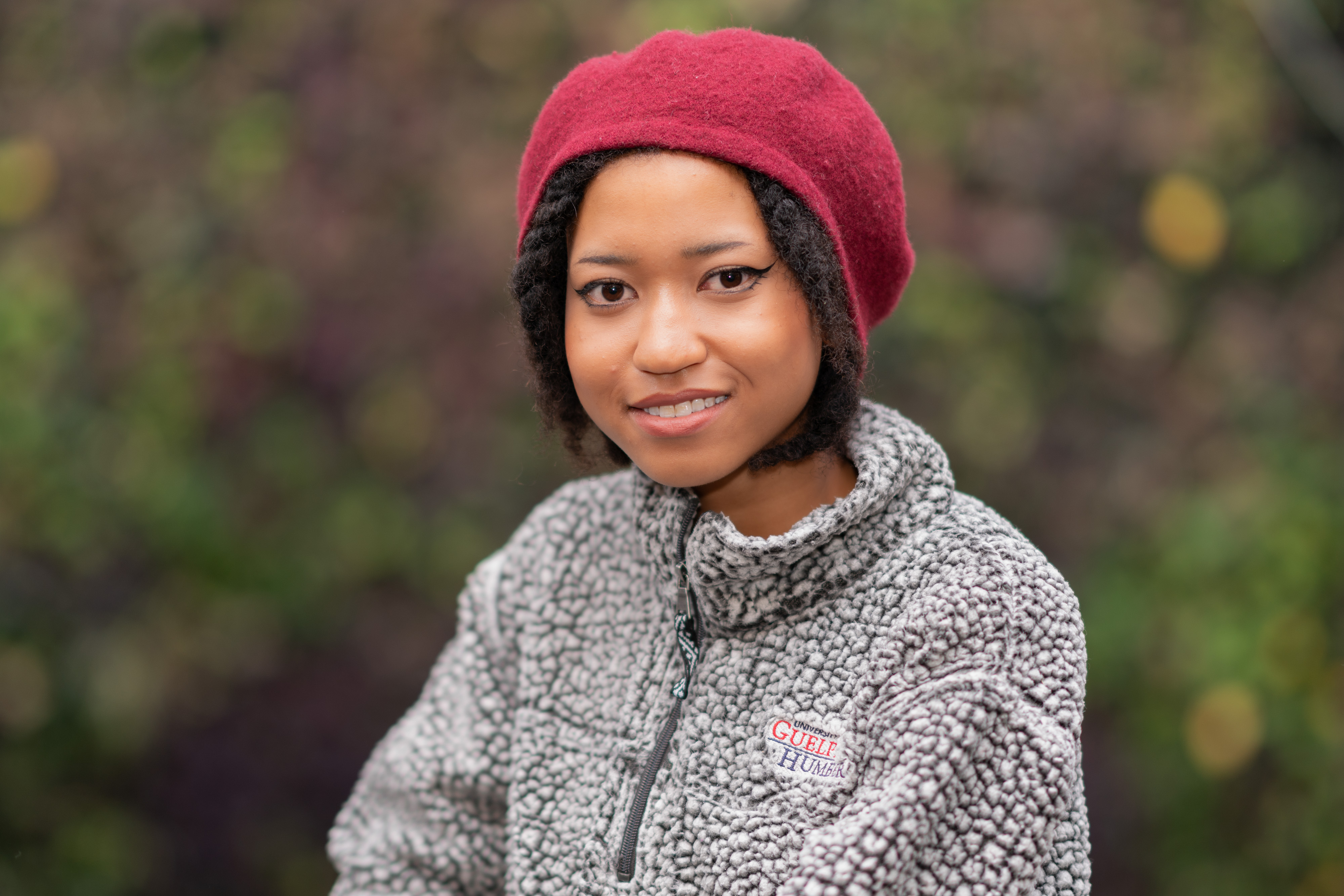 A portrait of a woman wearing a red hat