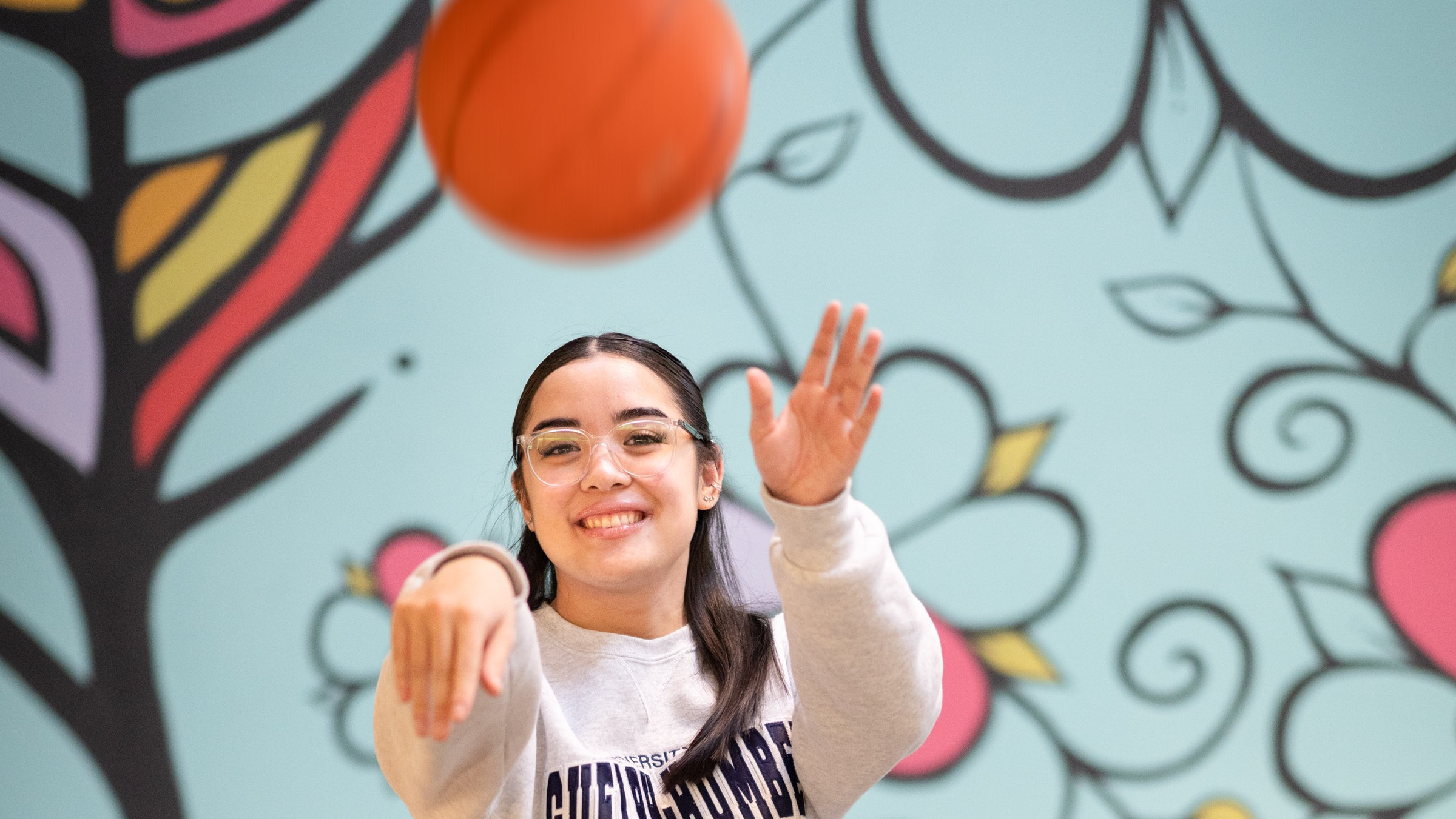 Hope tosses a basketball at the camera