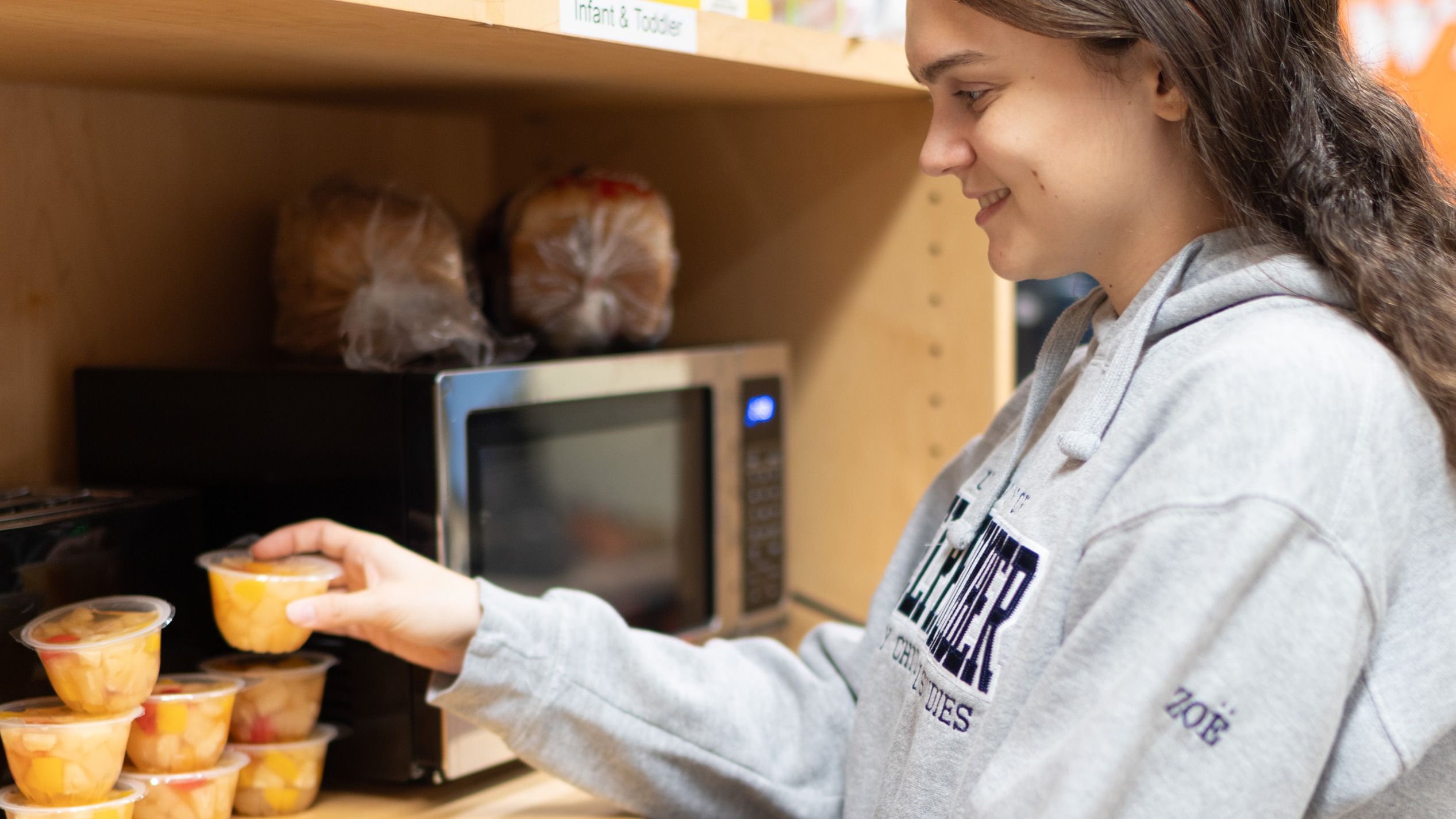 Student holding a fruit cup