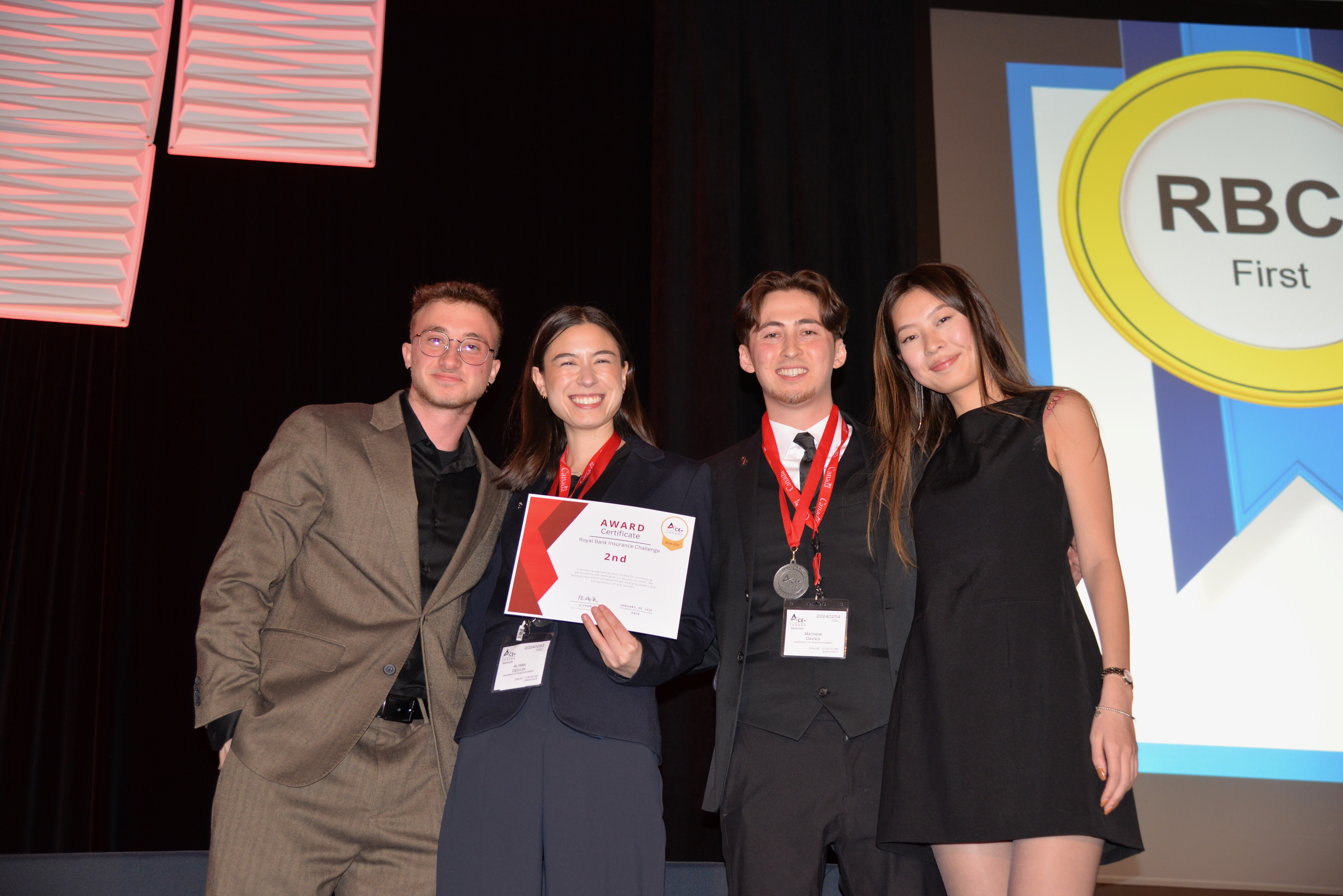 ACE U of GH co-presidents pose with two other people while holding second place certificate