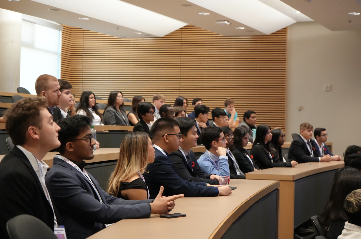 Students sit in a lecture hall listening