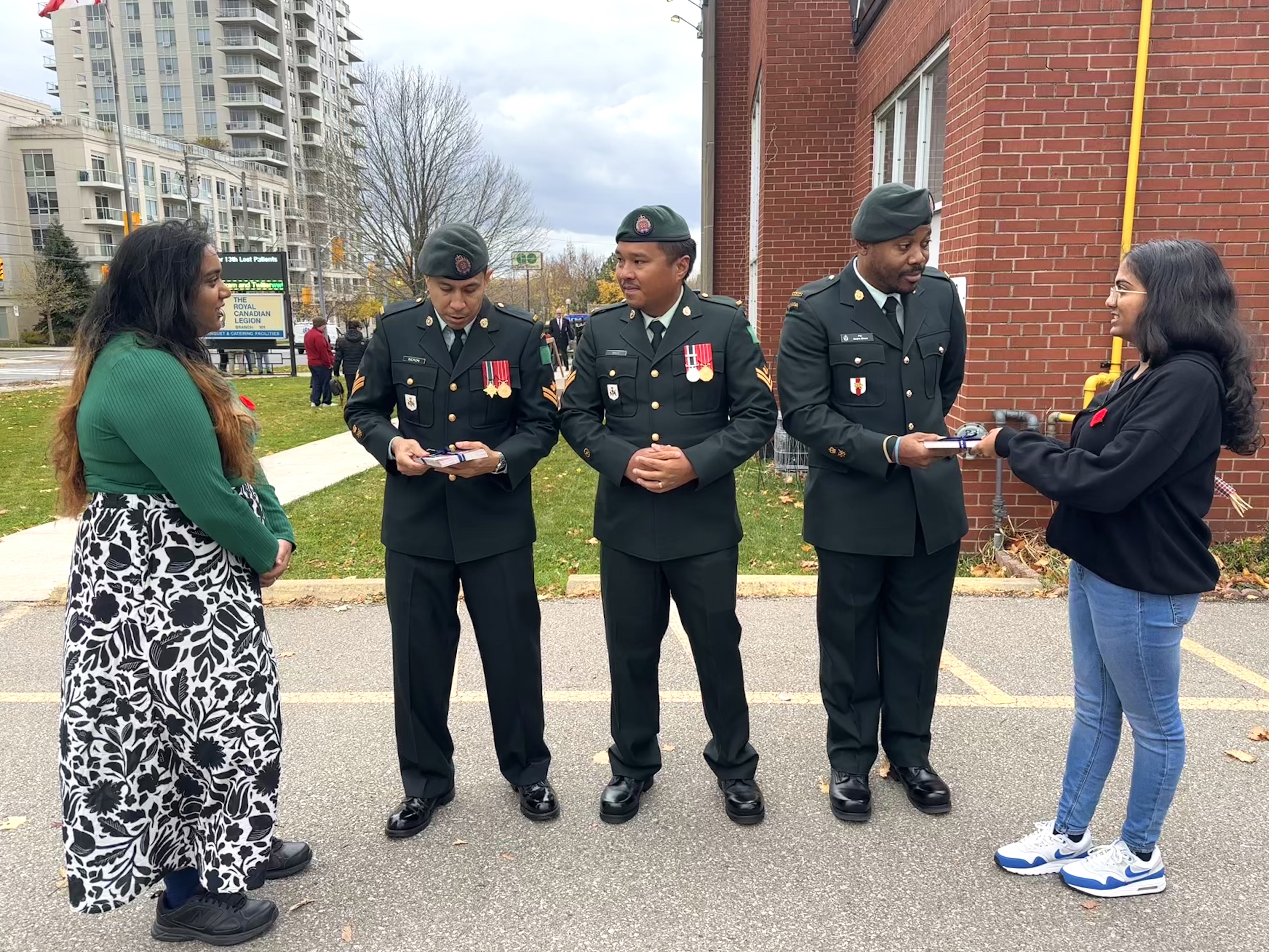 Students distribute postcards to war veterans at the Legion