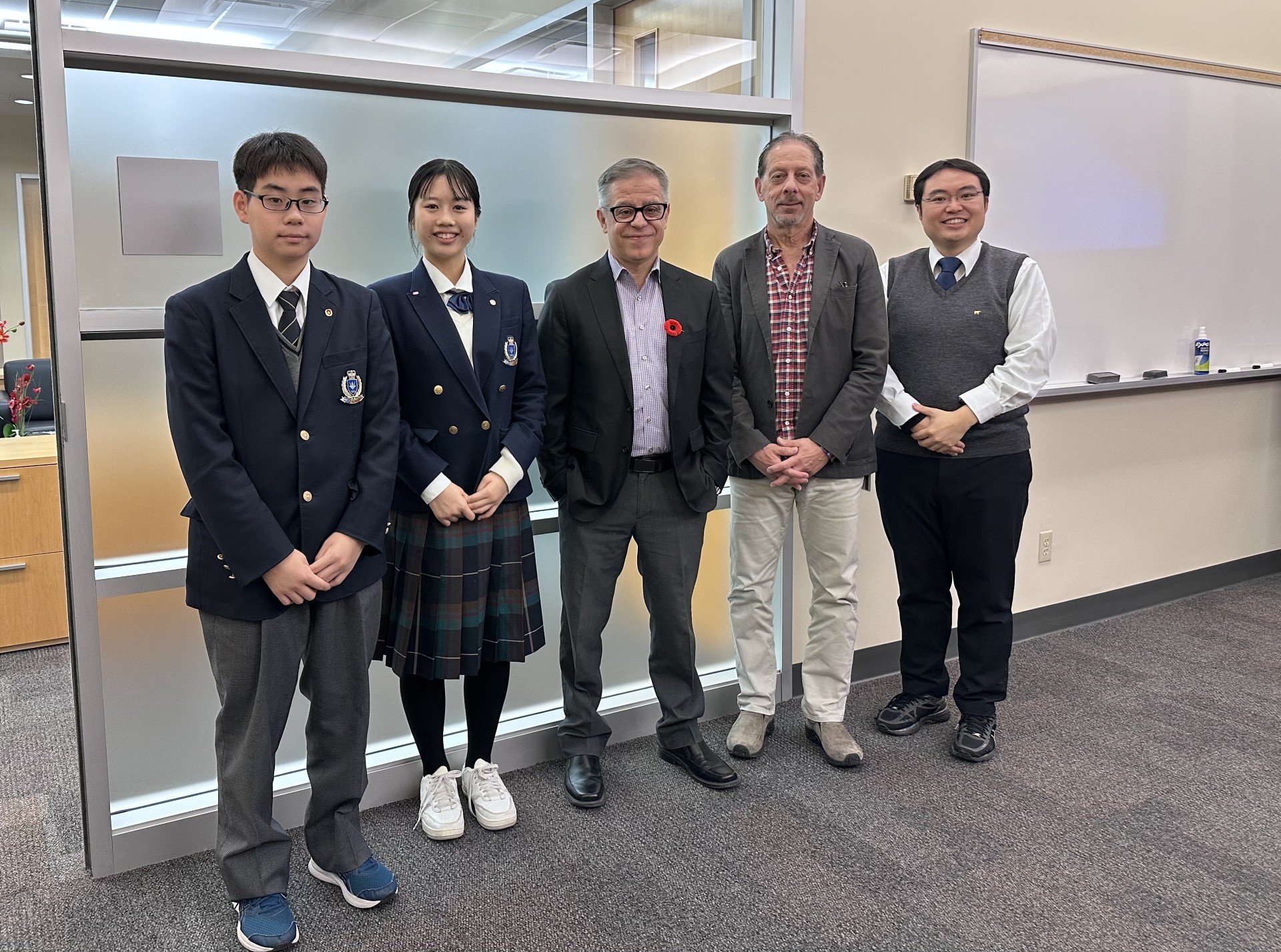 A group of five people pose for a photo at the University of Guelph-Humber