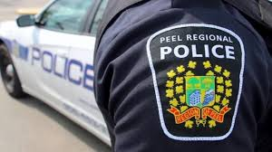 Shoulder flash of Uniformed Peel Police Officer and police vehicle