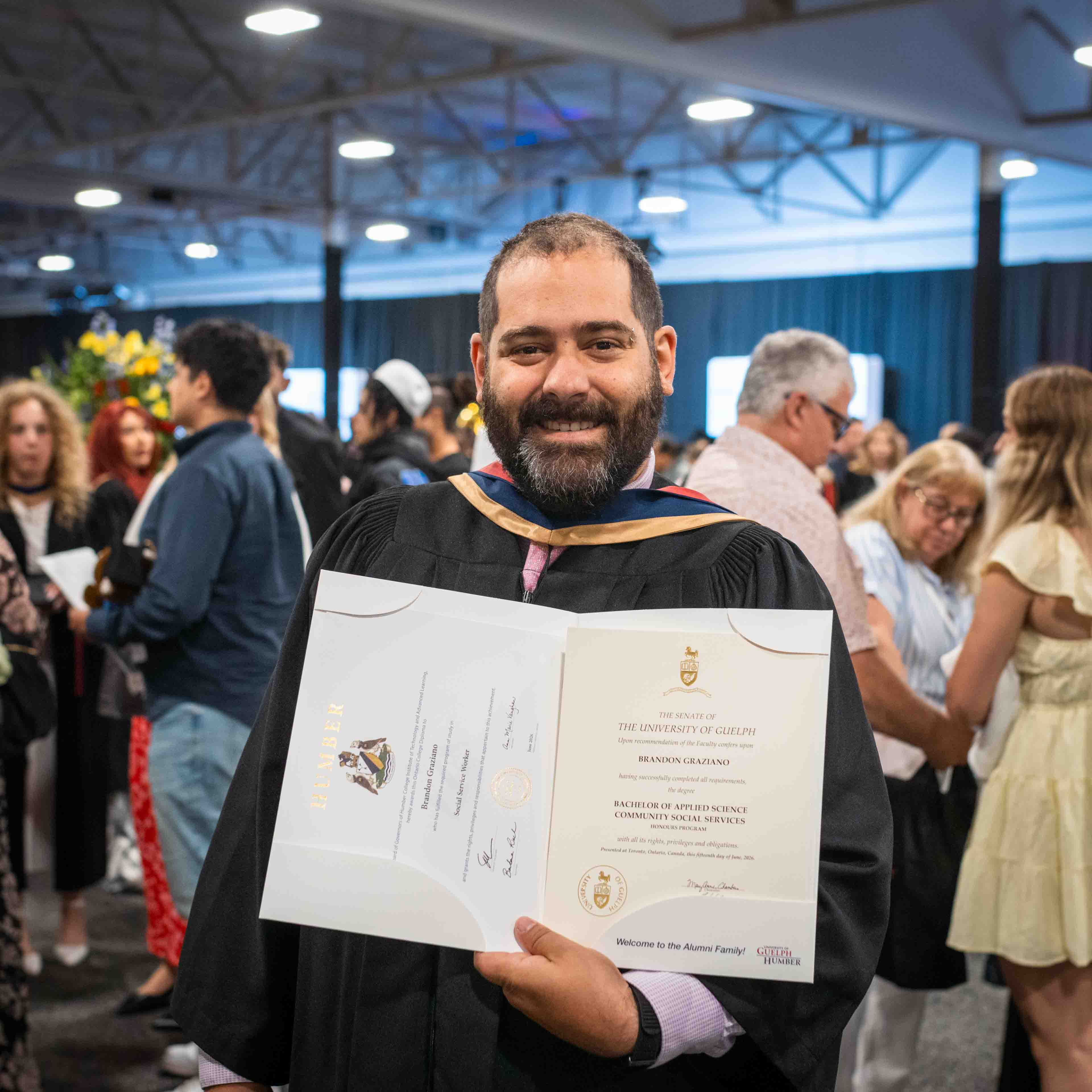 Brandon Graziano holds his parchments on convocation day