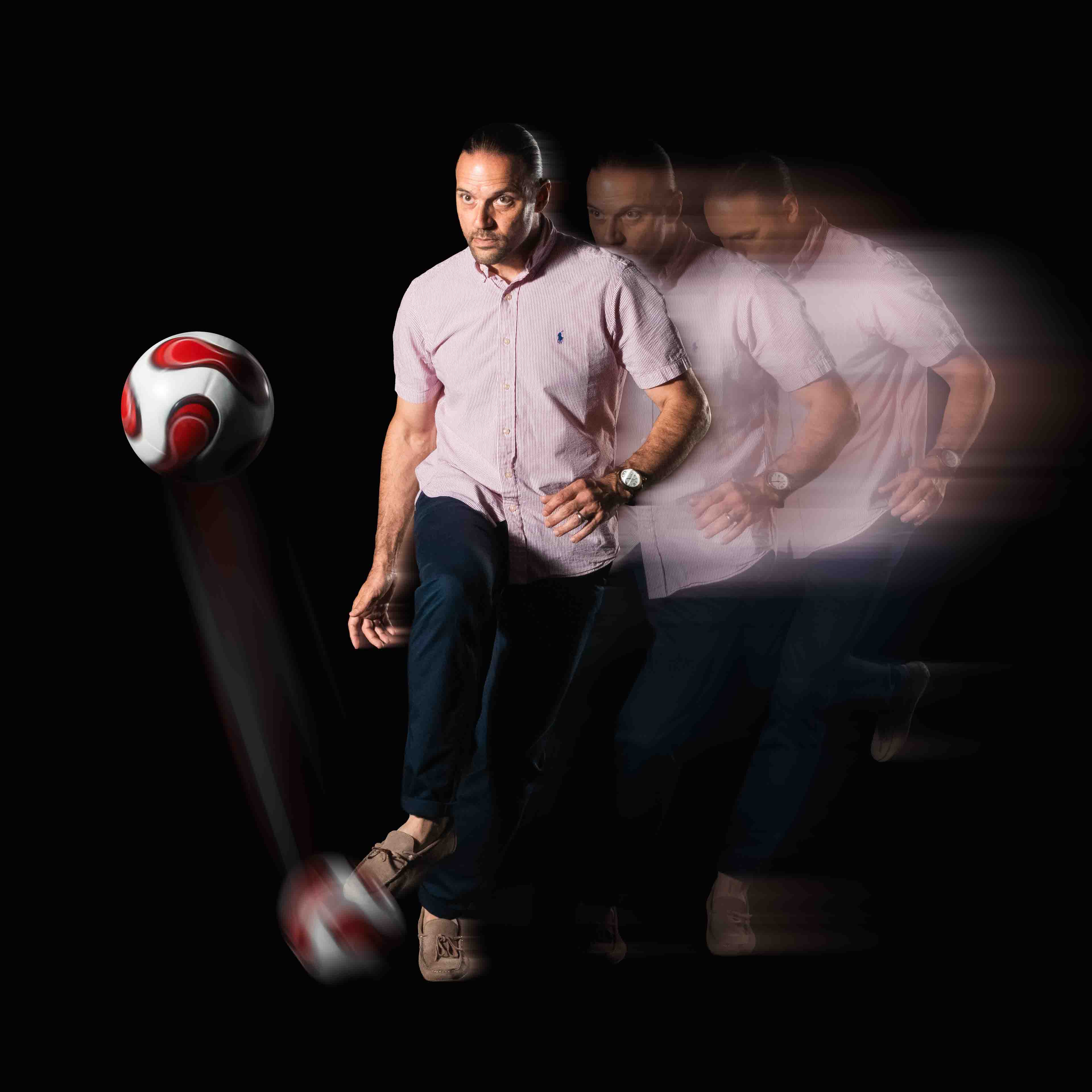 Motion photo of Dr. Richard Bucciarelli kicking a soccer ball