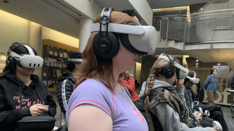 A group of students wear VR goggles