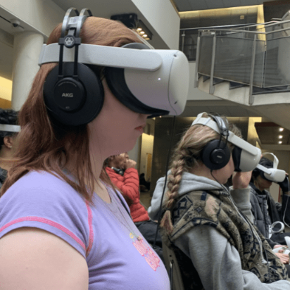 A group of students wear VR goggles