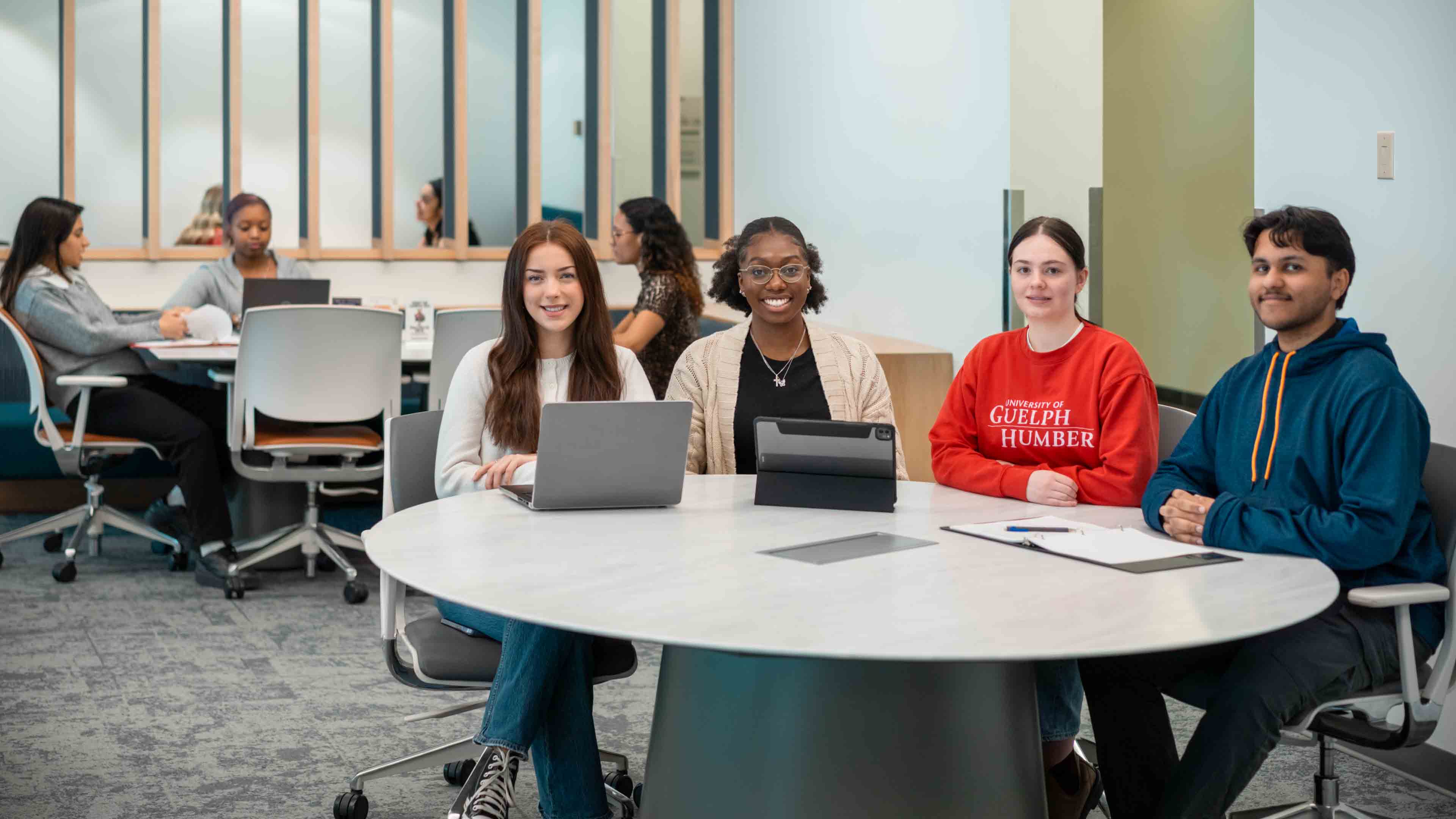 A group of students sit around a table