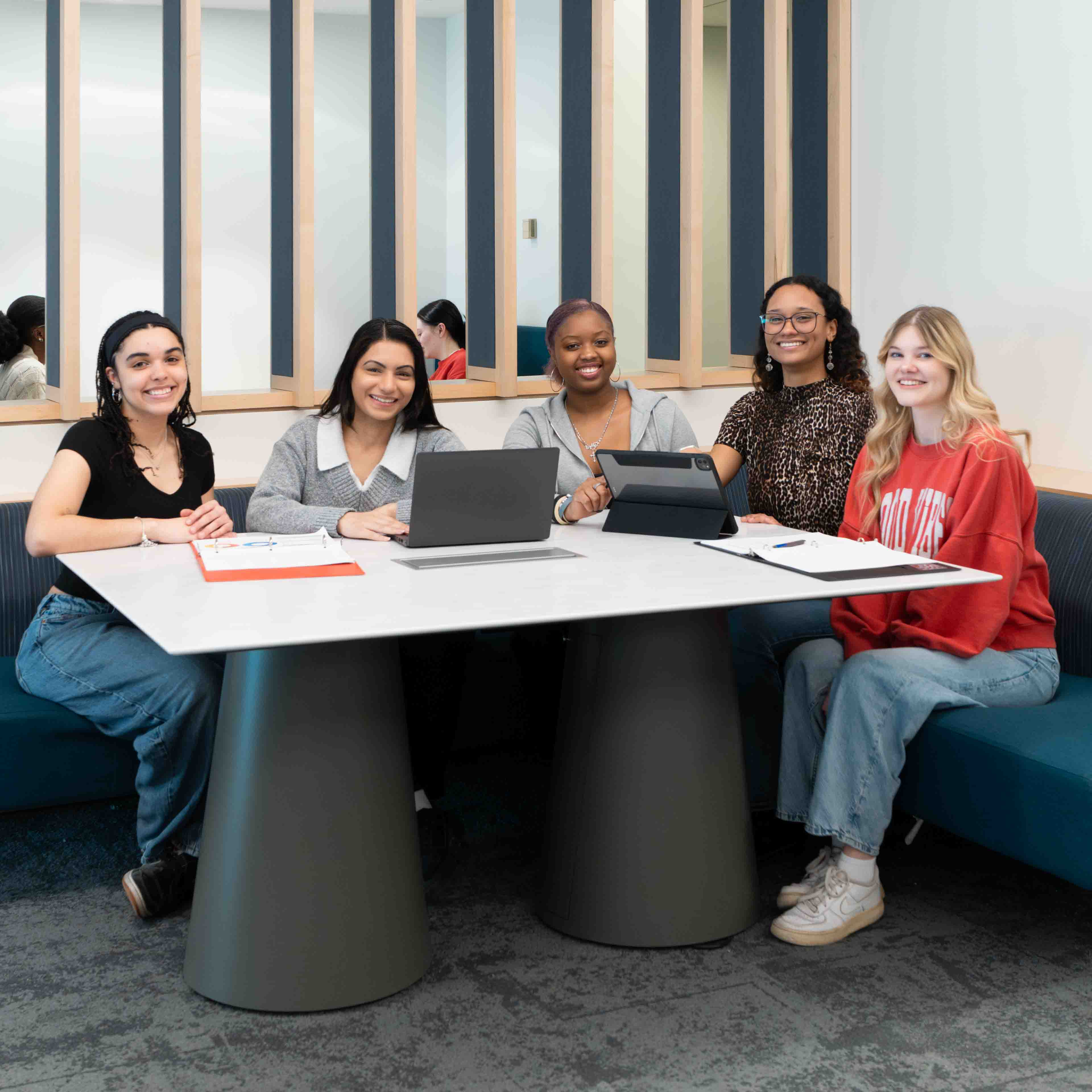 A group of students sit around a table