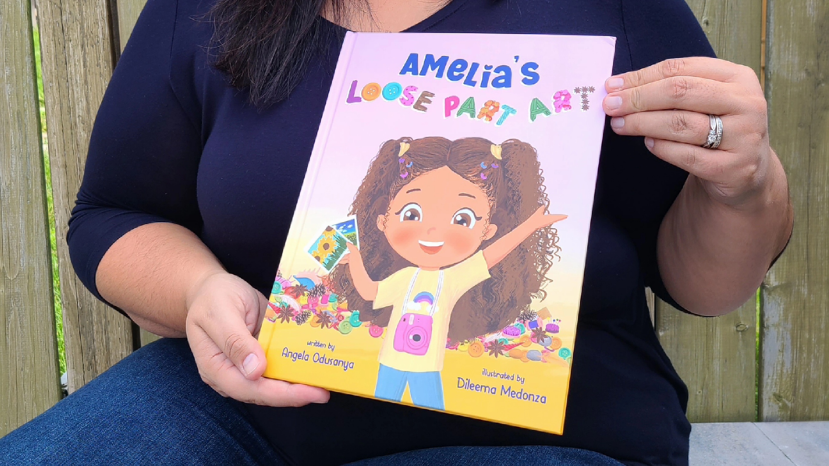 Angela Odusanya holding her published children&#039;s book