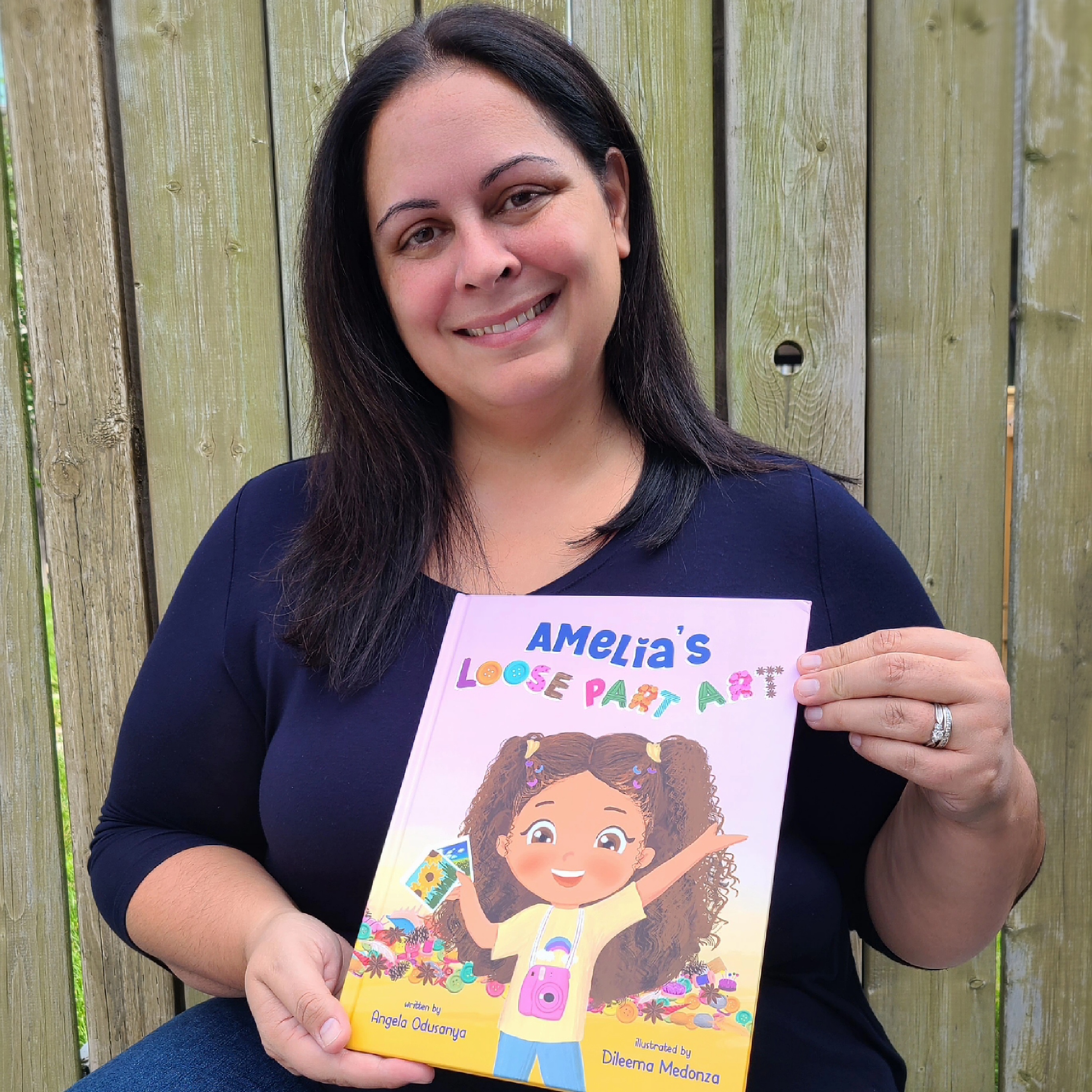 Angela Odusanya holding her published children&#039;s book