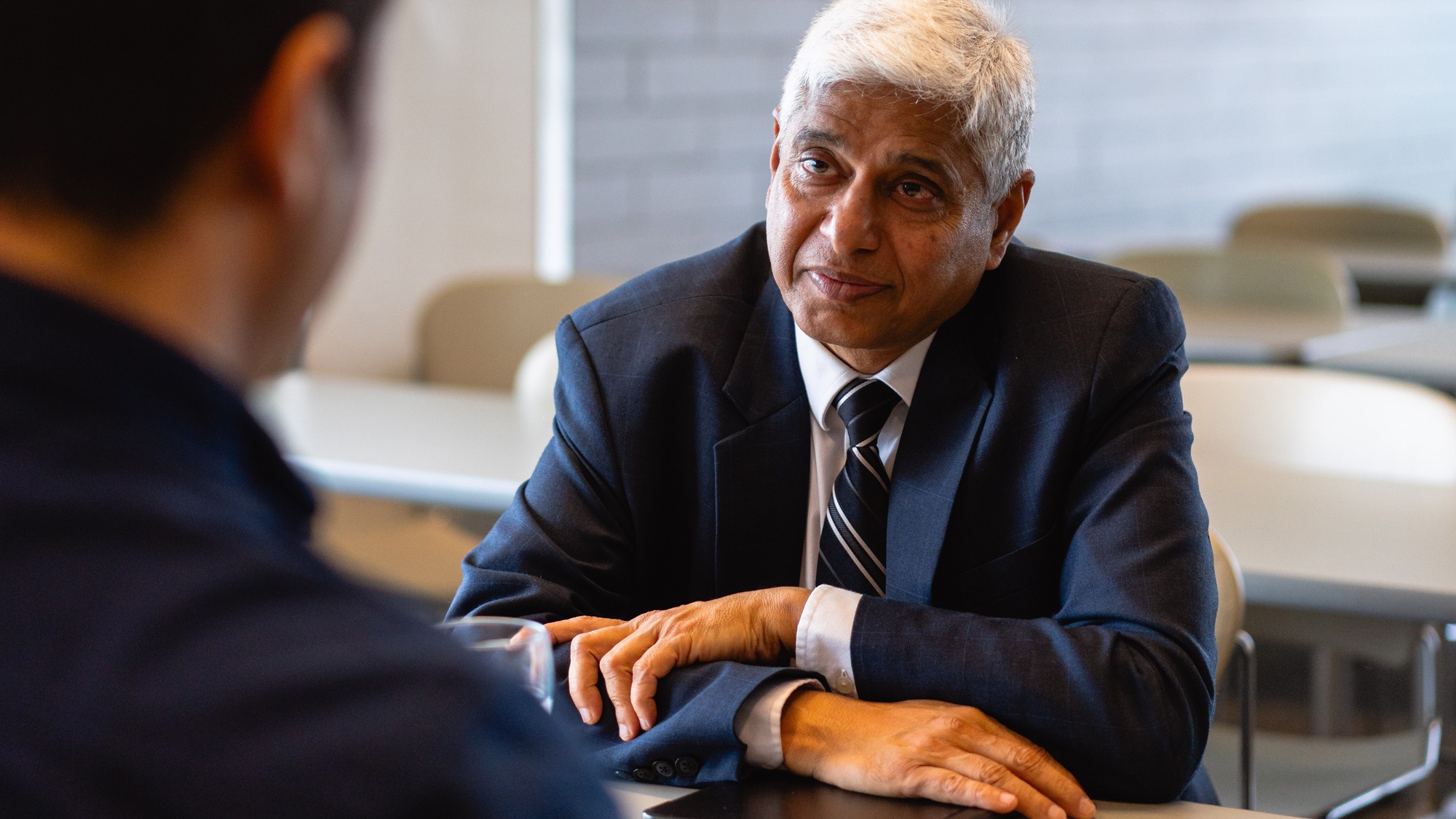 Dr. Vikas Swarup sitting at a table.