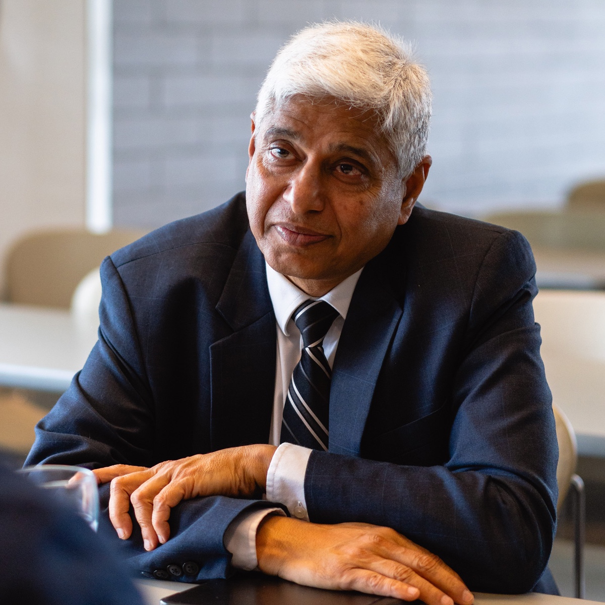 Dr. Vikas Swarup sitting at a table.