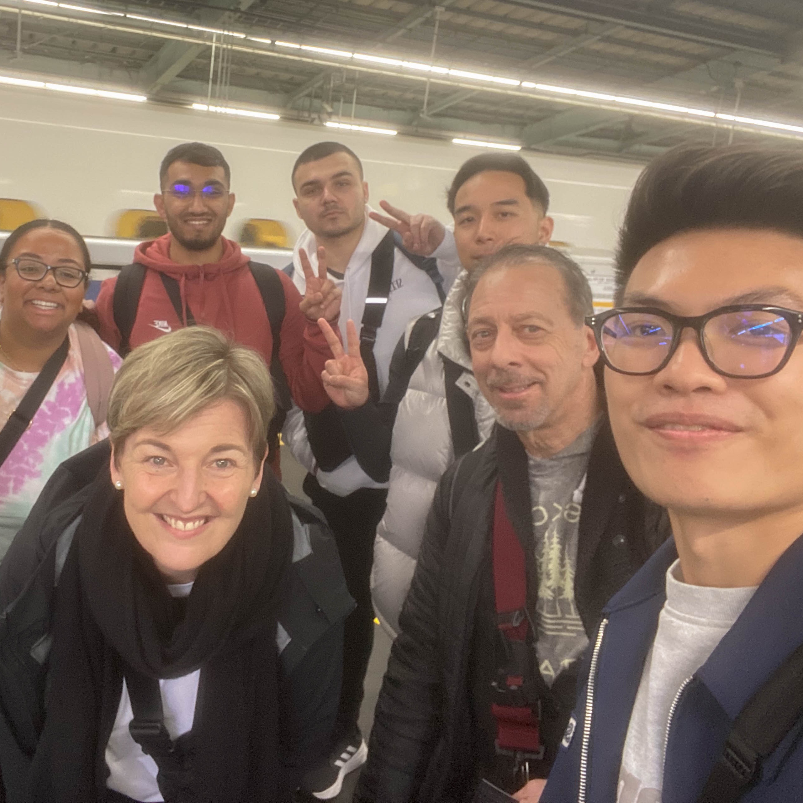 A group of individuals smiling for a selfie