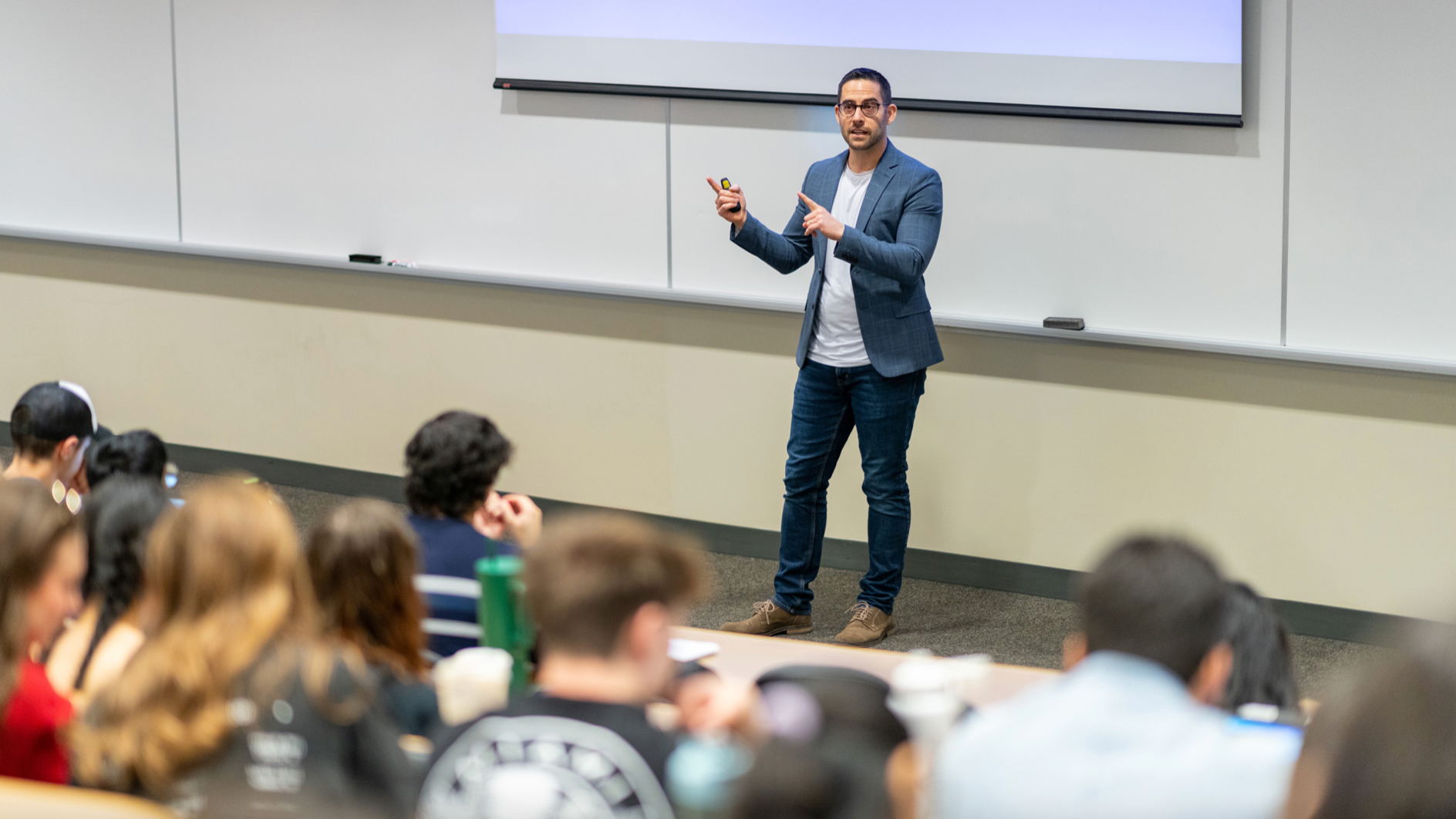 Joseph Gibbons standing at the front of a classroom lecturing students