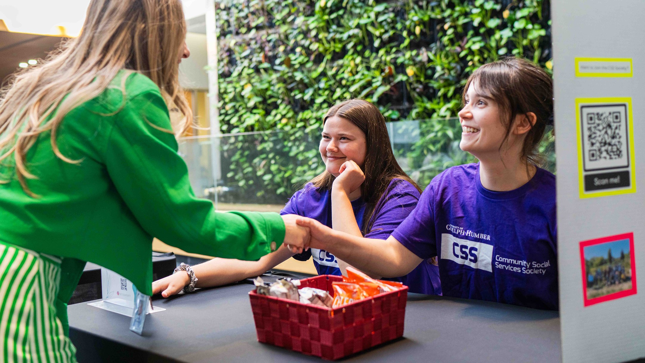 UofGH community member meets the CSS Society, shakes hands