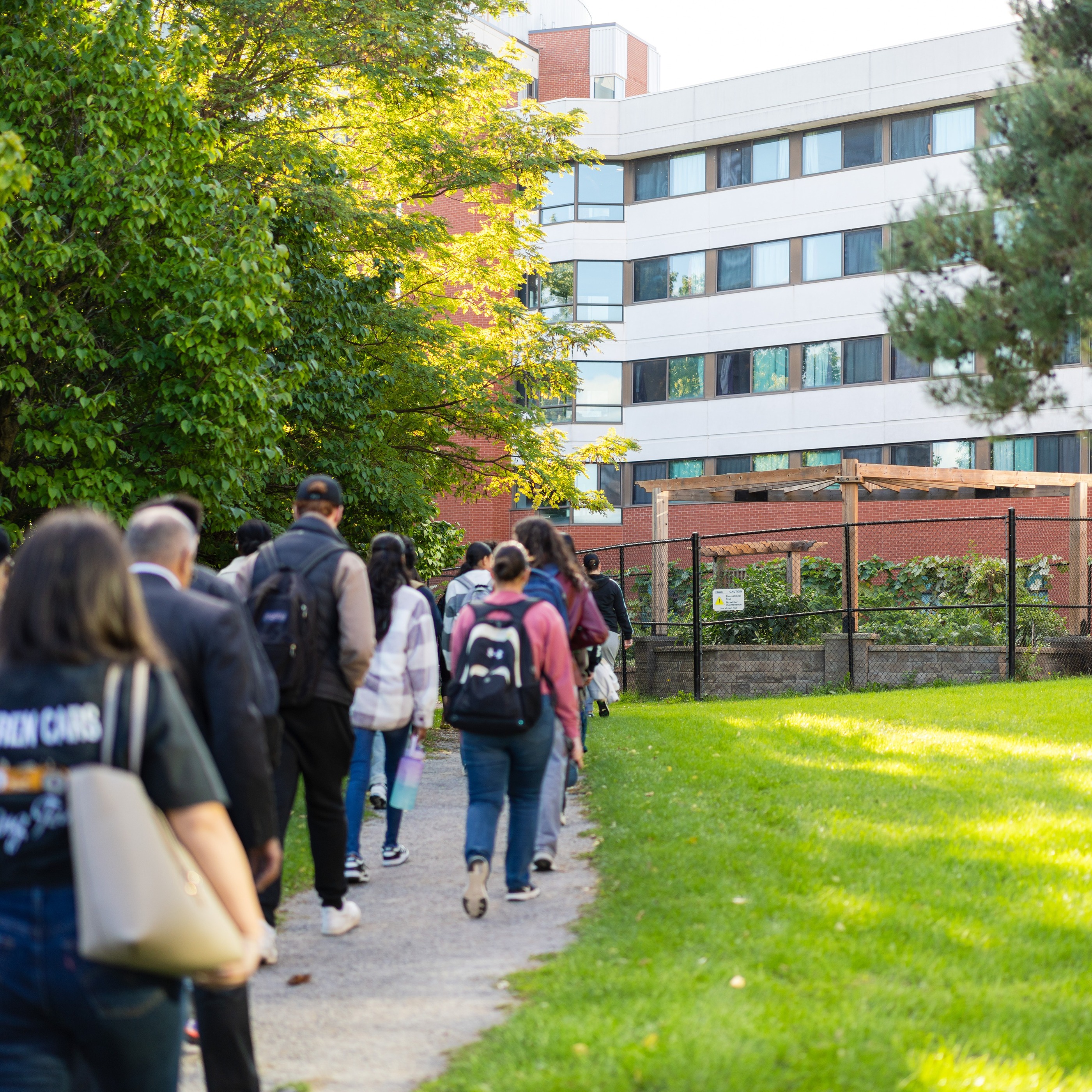 A group of students walking toward the Humber Food Learning Garden