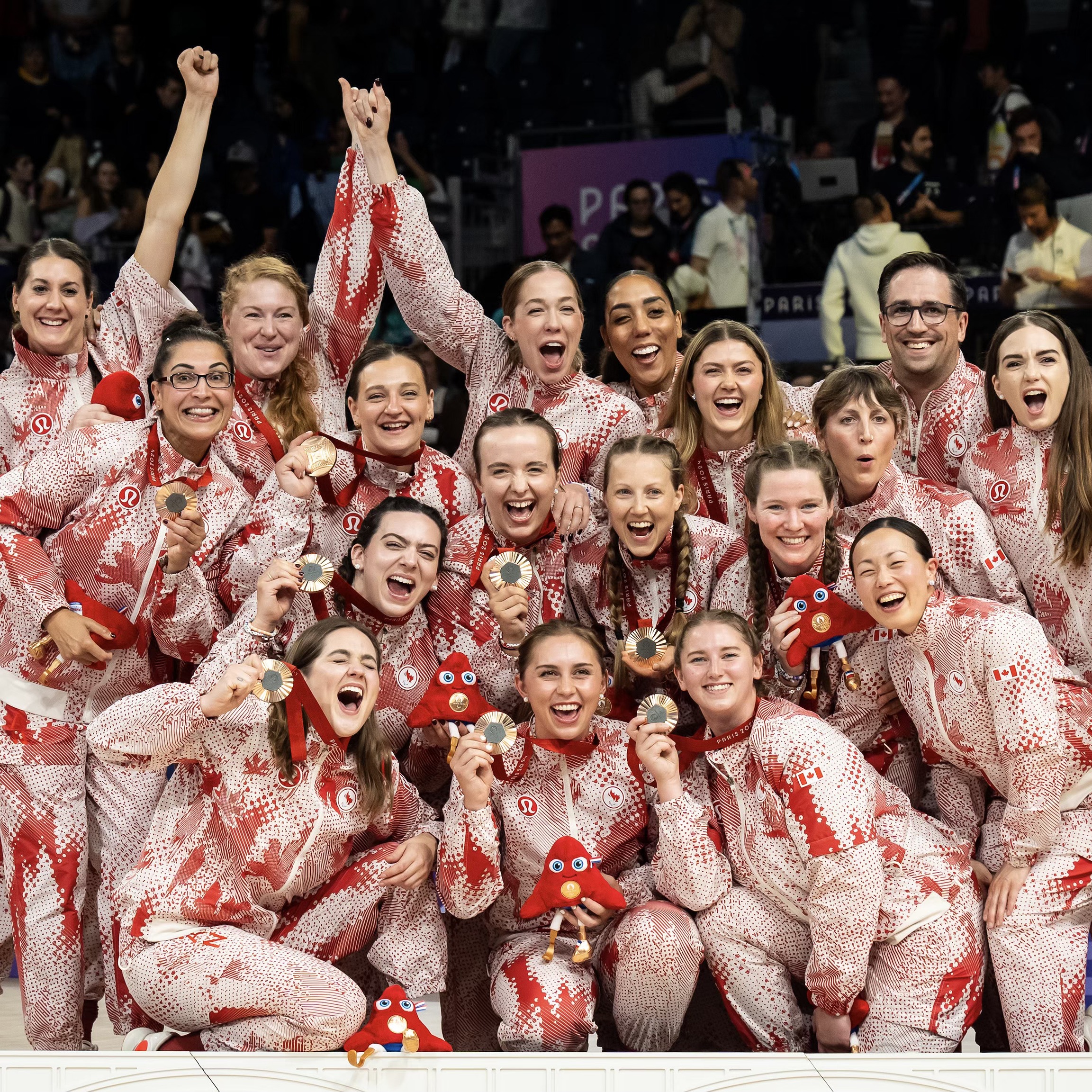 Team holding Olympic medals at Paris Paralympics