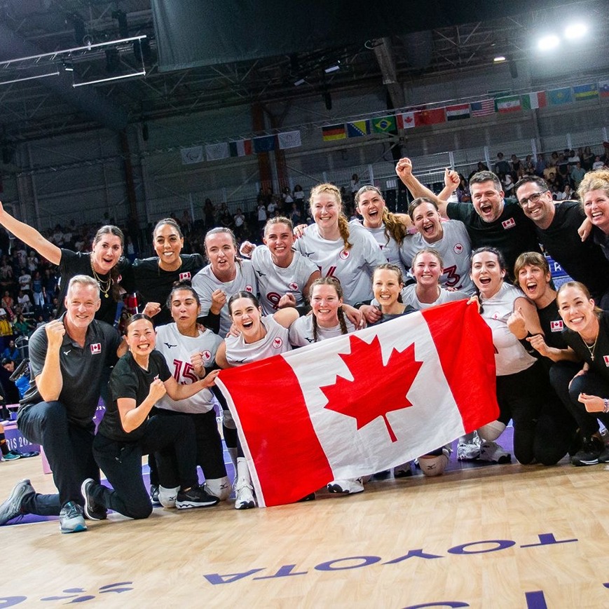 The team holds a Canadian flag at the Paris Paralympics