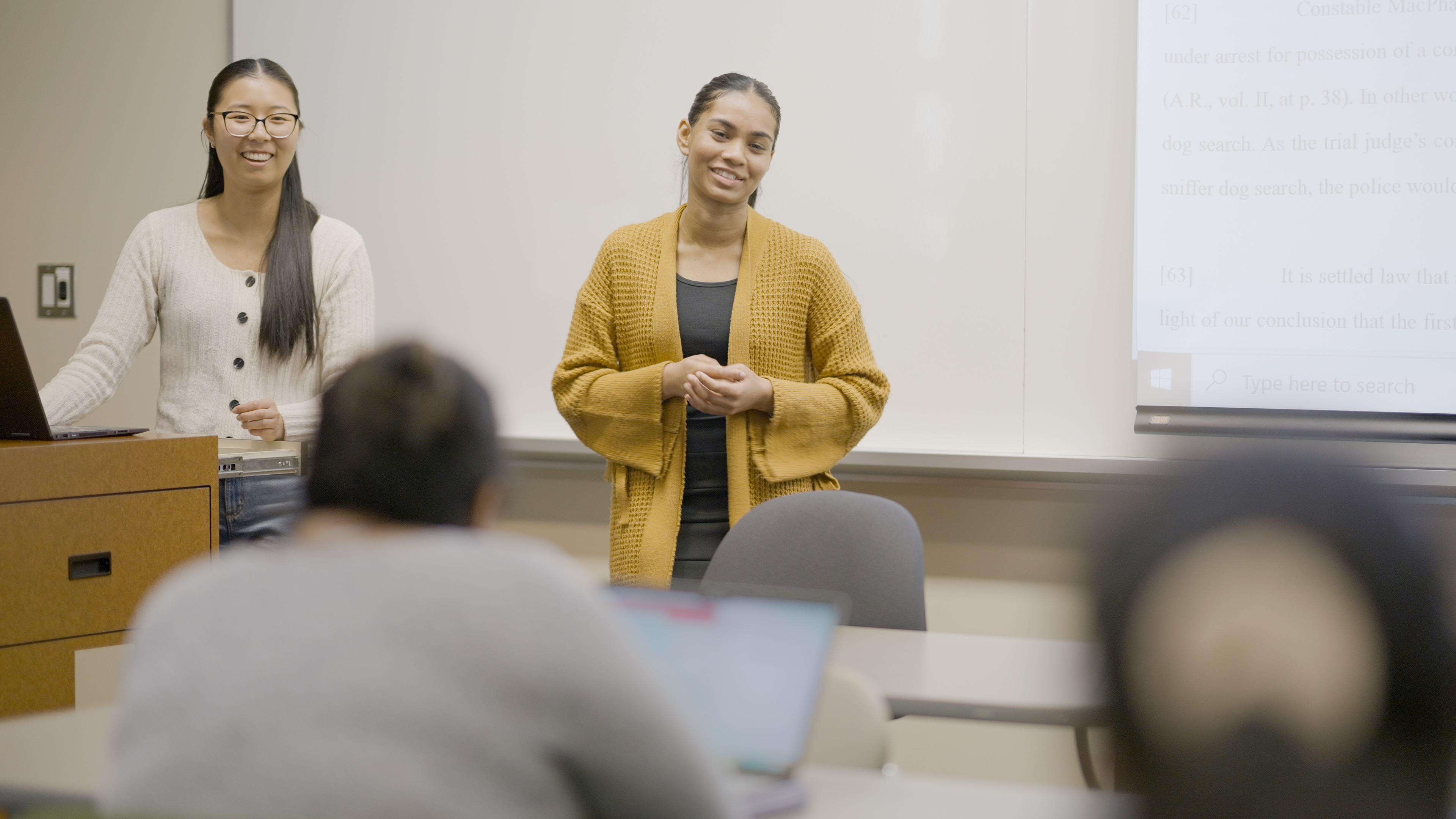 Students speaking at a podium