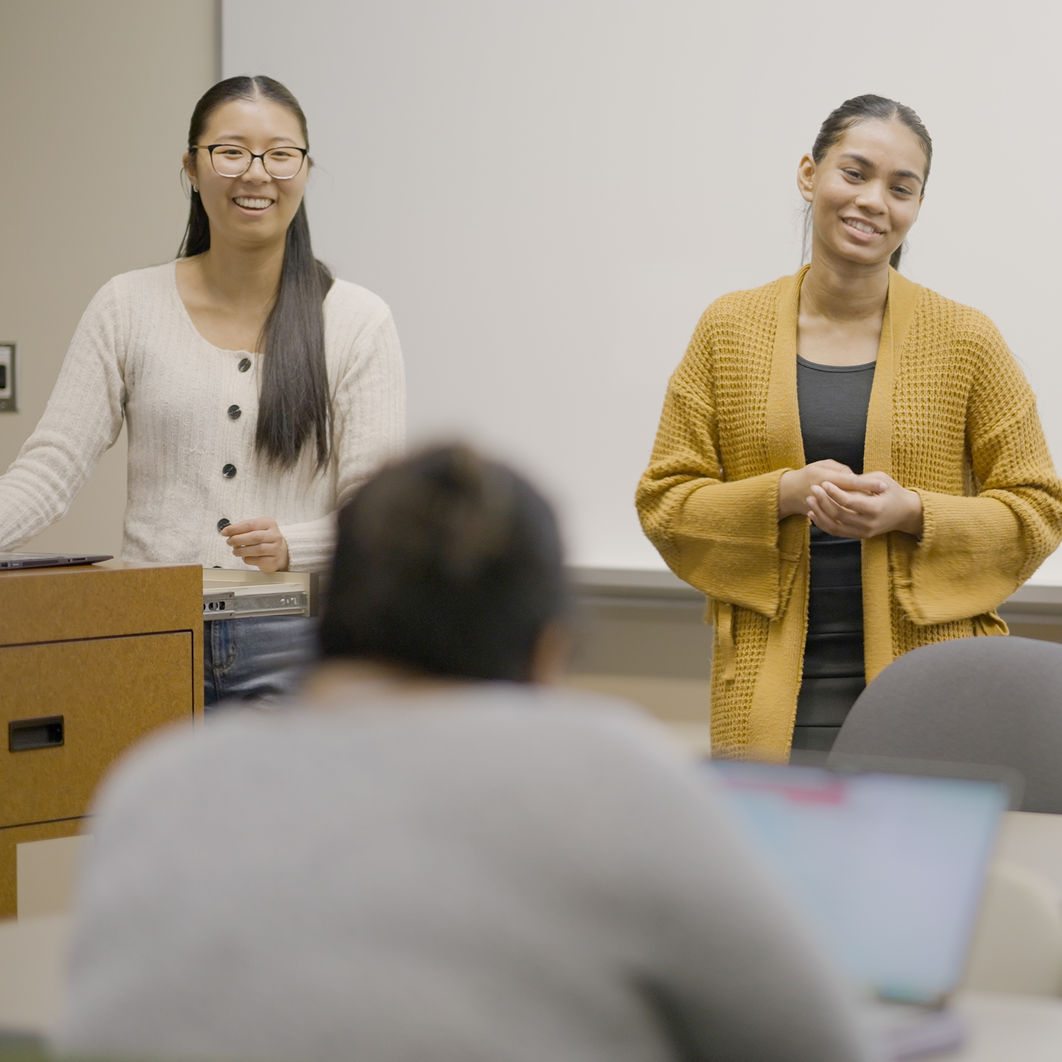 Students speaking at a podium