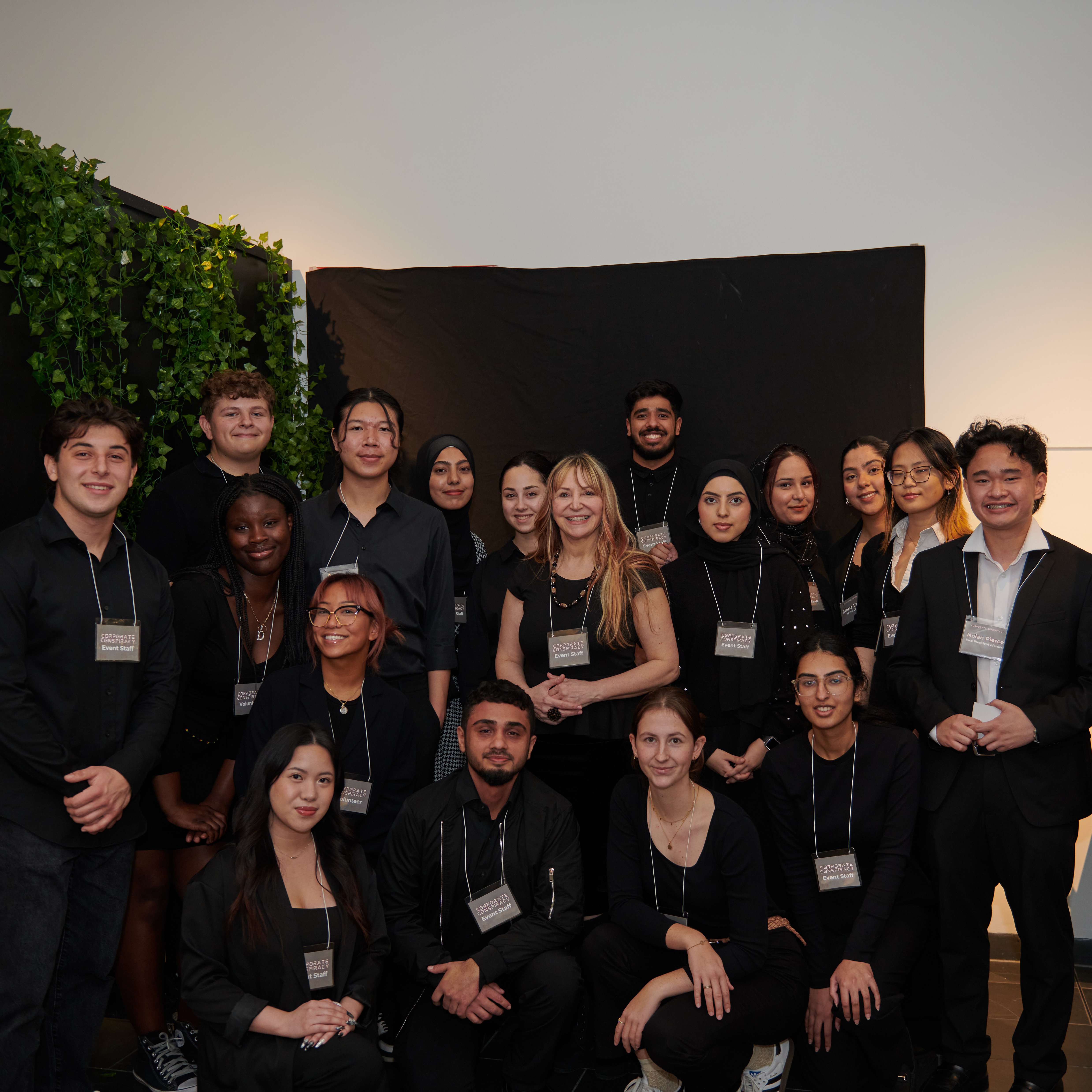 A group of people posing while wearing name tags