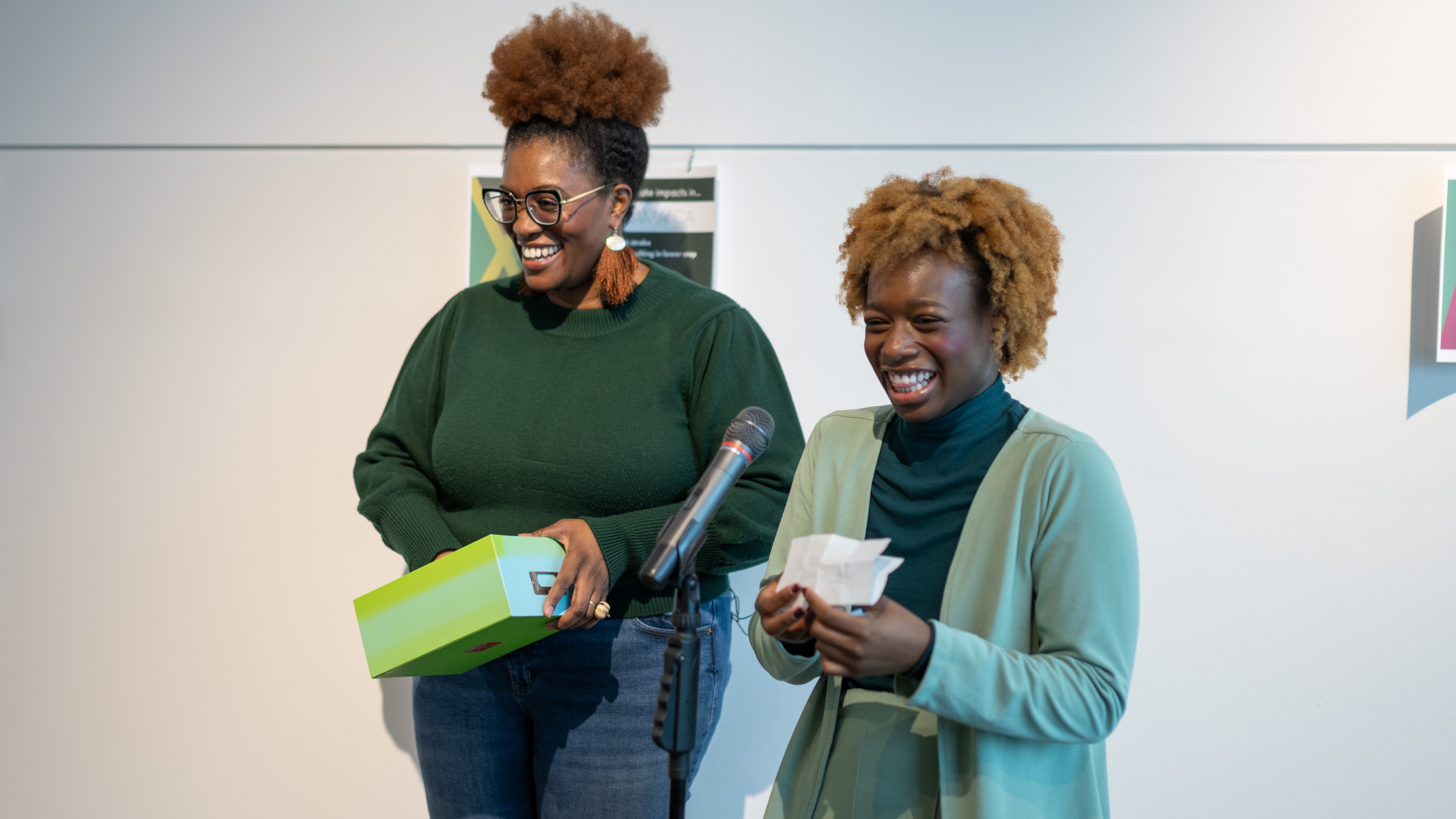 Guelph-Humber student Jada Wallace speaks into a microphone beside Zamani Ra