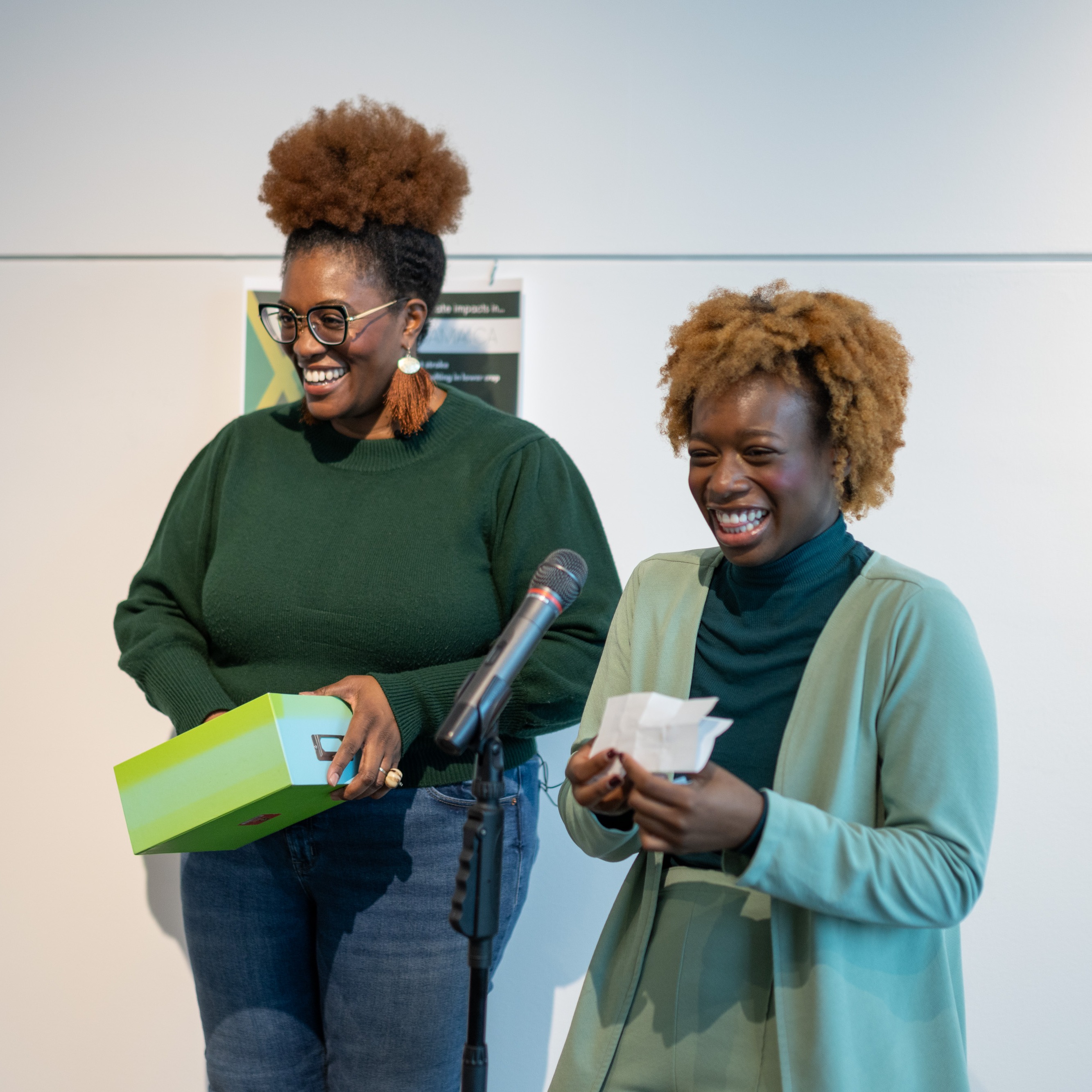 Guelph-Humber student Jada Wallace speaks into a microphone beside Zamani Ra