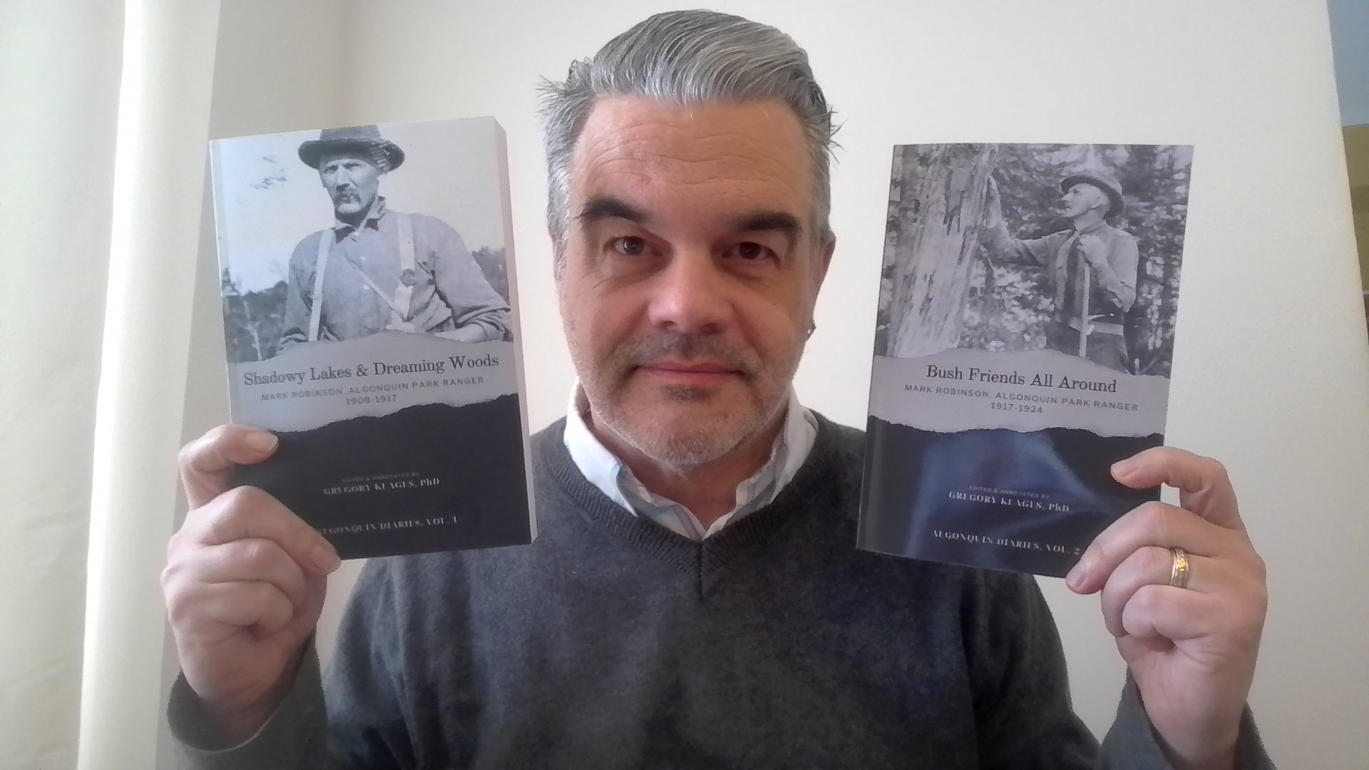 Dr. Gregory Klages holds up two of his books