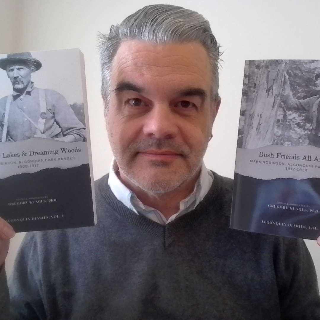 Dr. Gregory Klages holds up two of his books