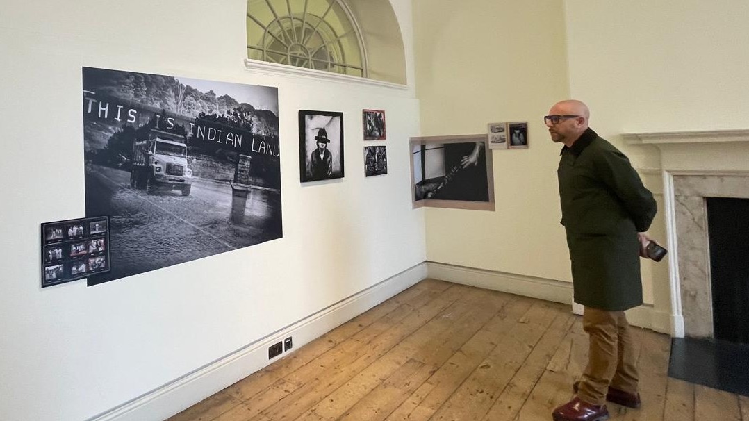 Giovanni Capriotti looks at the gallery of his project Terra Nullius in London, England
