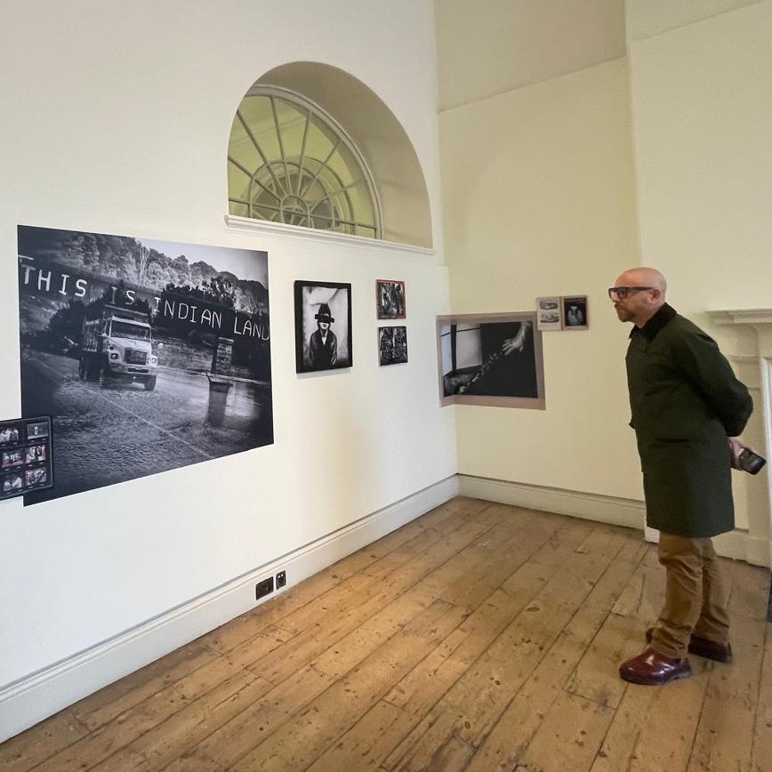 Giovanni Capriotti looks at the gallery of his project Terra Nullius in London, England