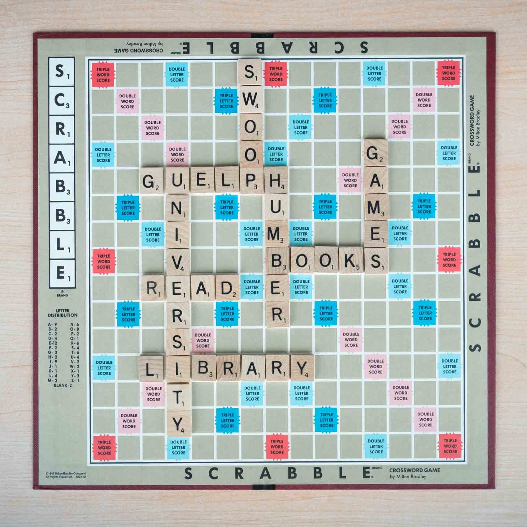 Aerial shot of a Scrabble board game with Guelph-Humber related words on the board like Swoop, Library, Guelph, Humber