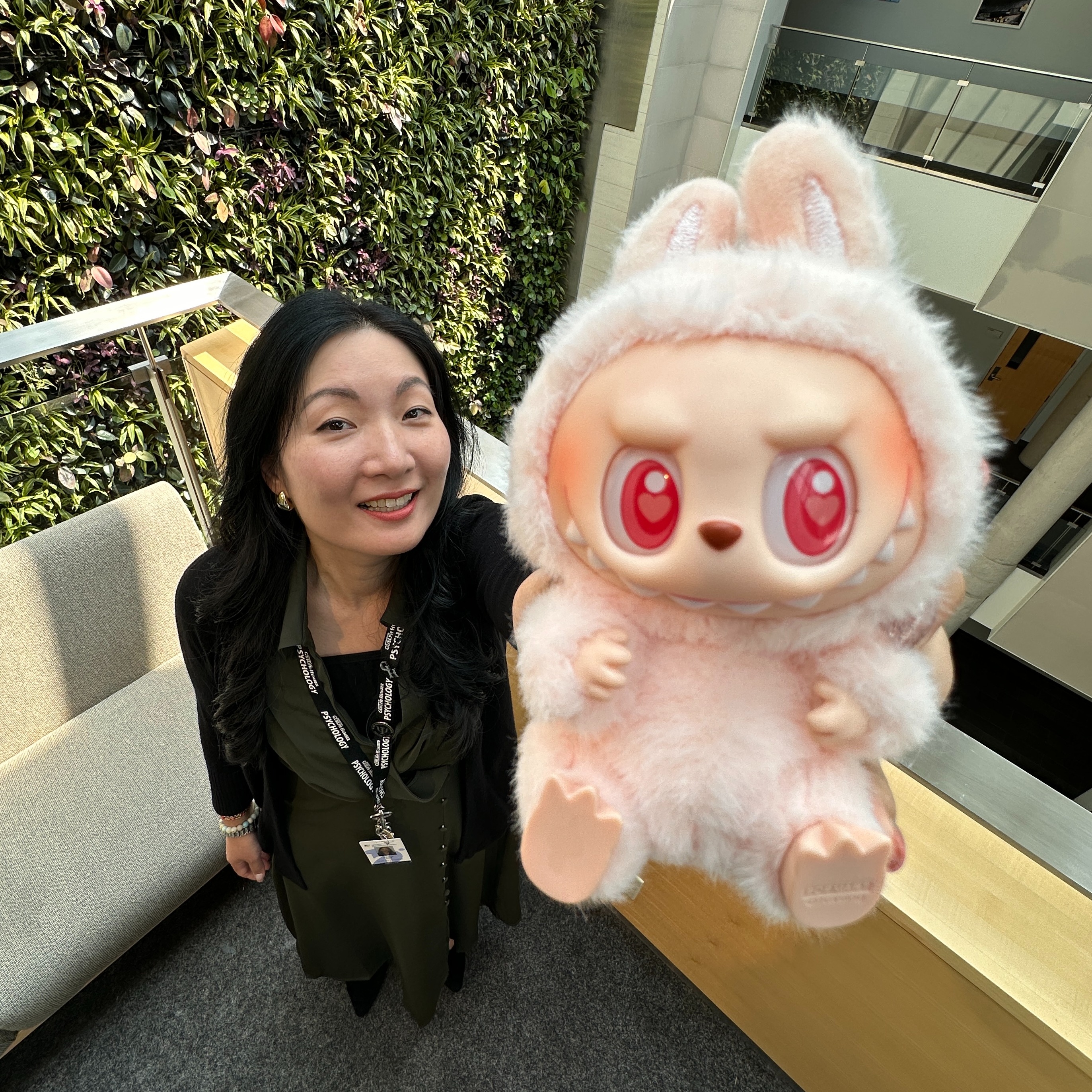 Dr. Alice Kim holds a pink Labubu up close to the camera
