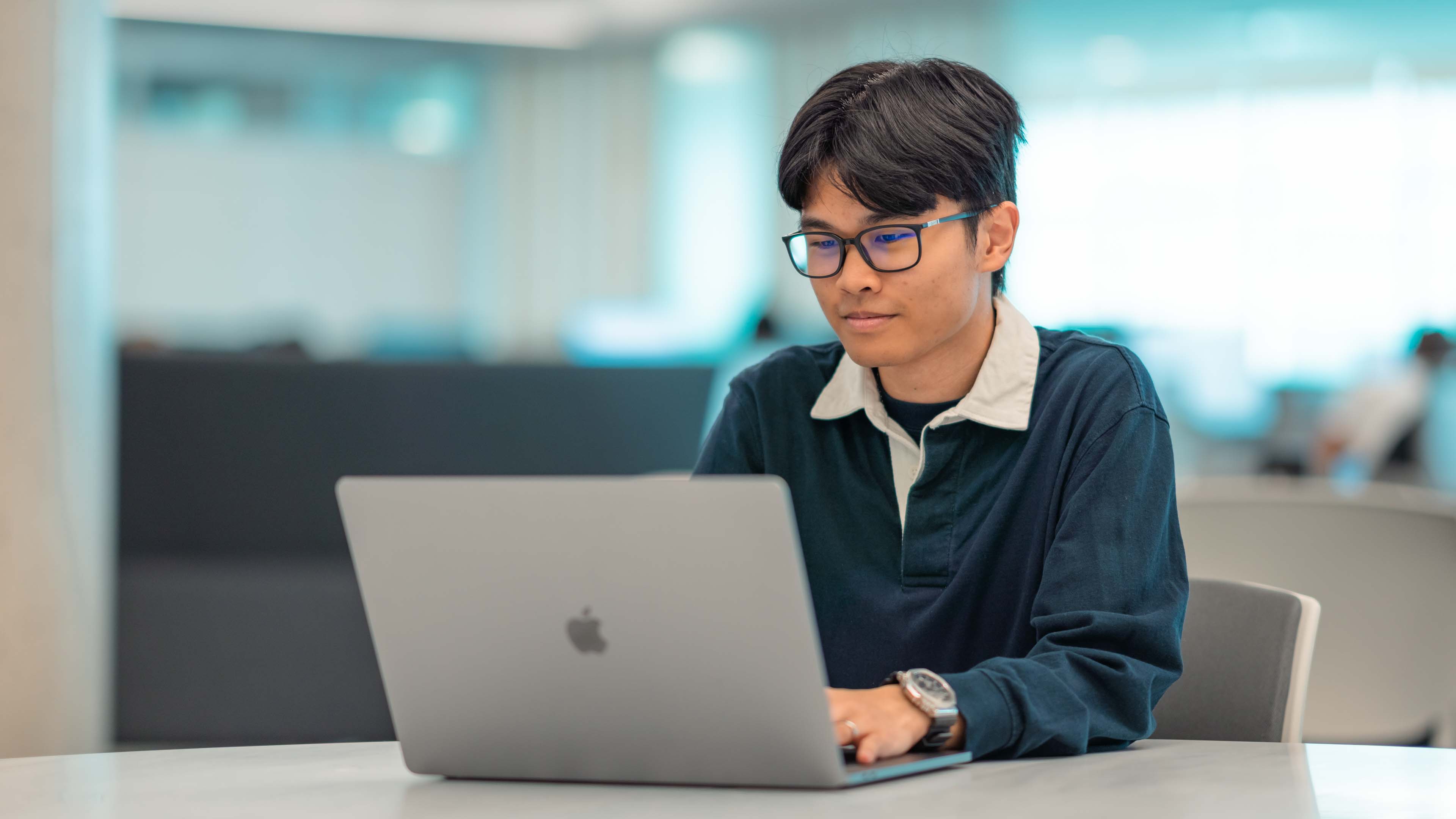 Male student looking at laptop computer