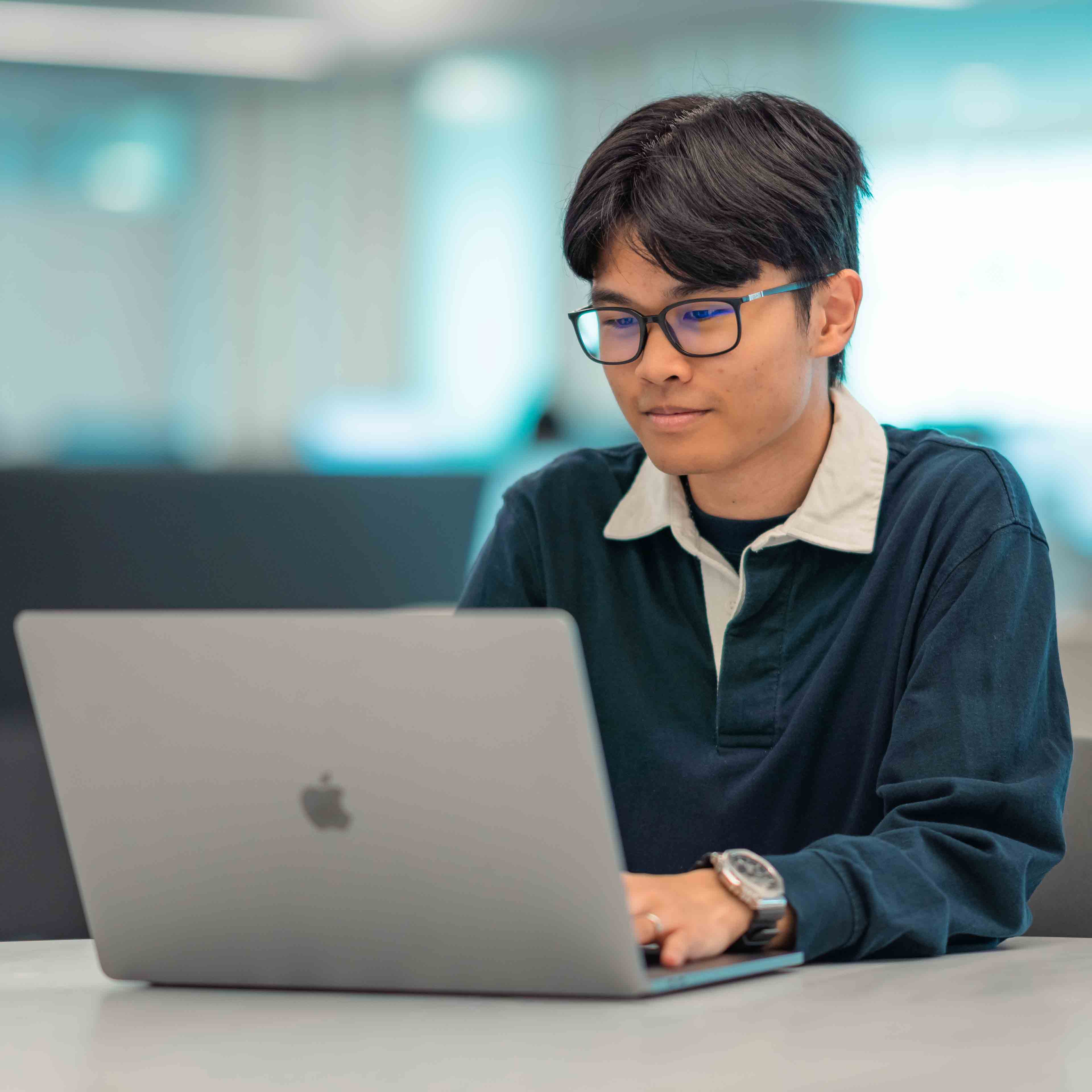 Male student looking at laptop computer
