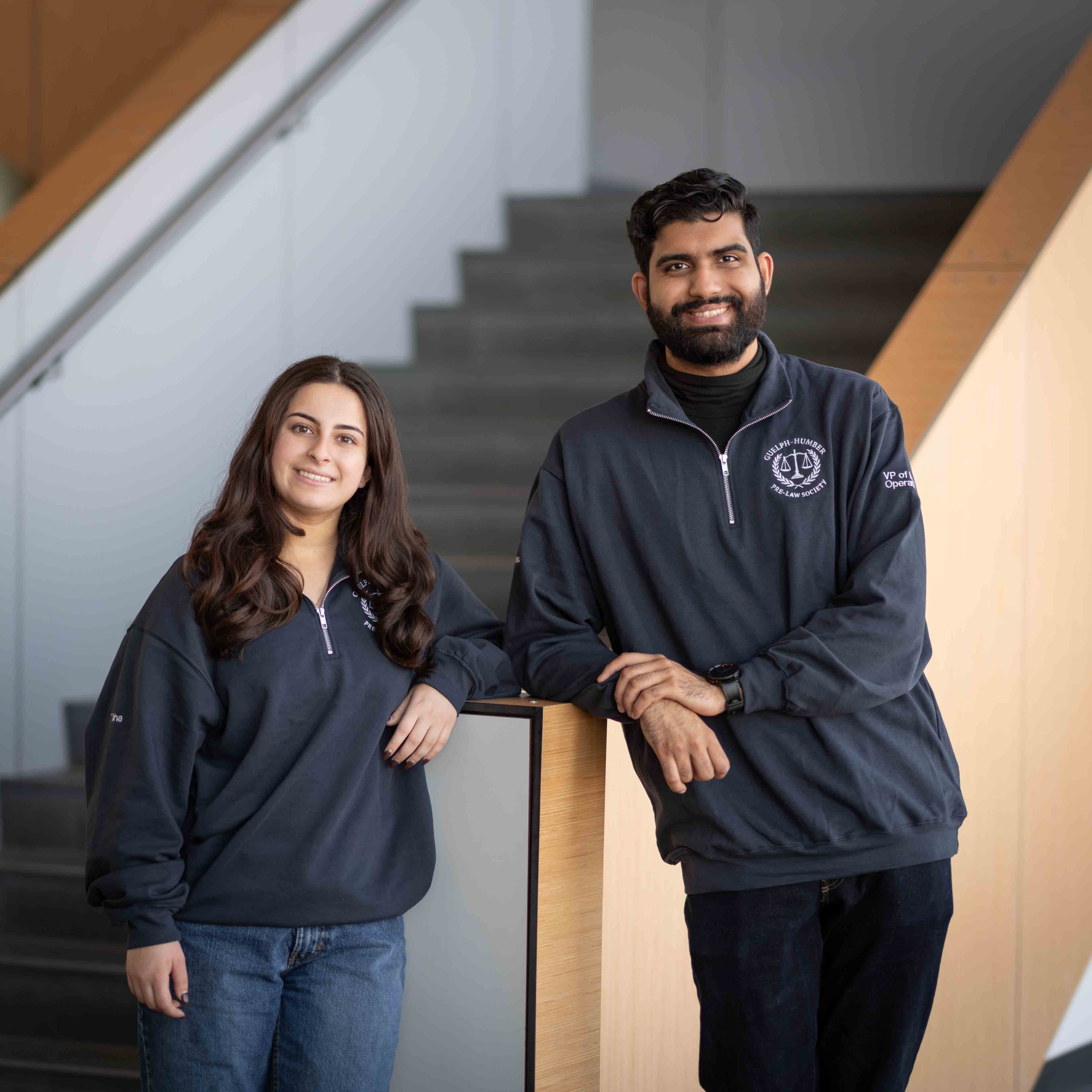 Tala and Ashon stand in front of a staircase