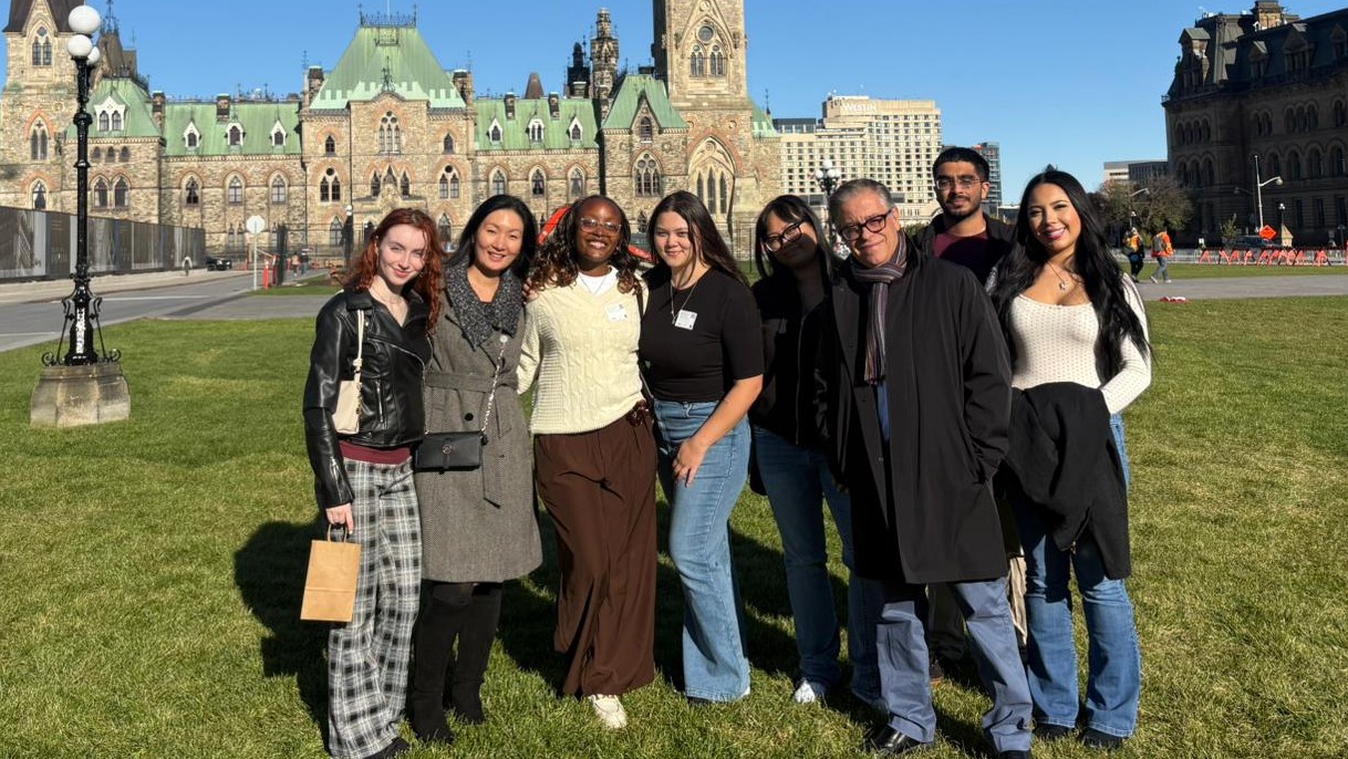 The six Agora Fellows, Dr. Kim, and Dr. Bragues stand in front of Parliament Hill