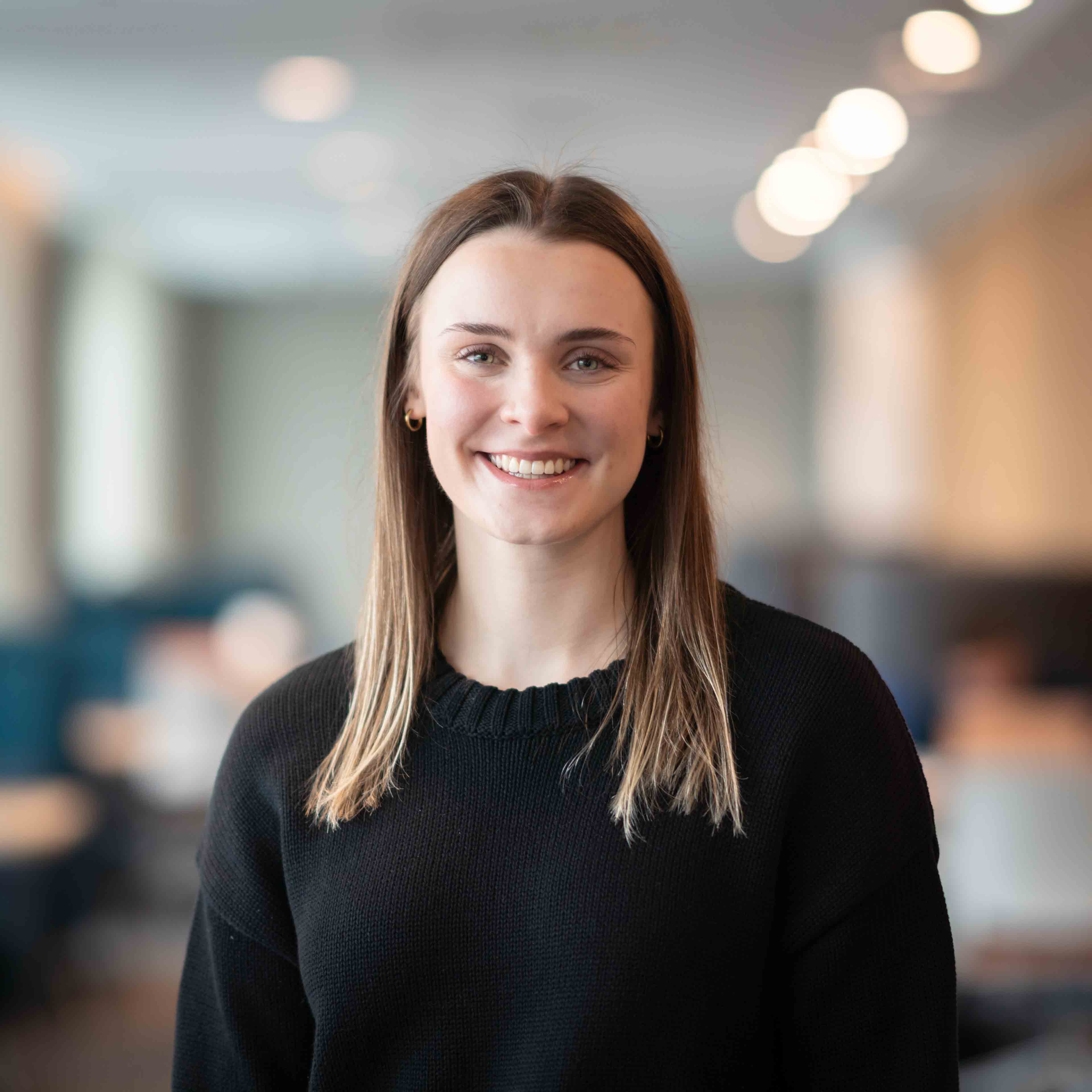 Veronica Wood smiles at the camera in front of a blurry background at Guelph-Humber