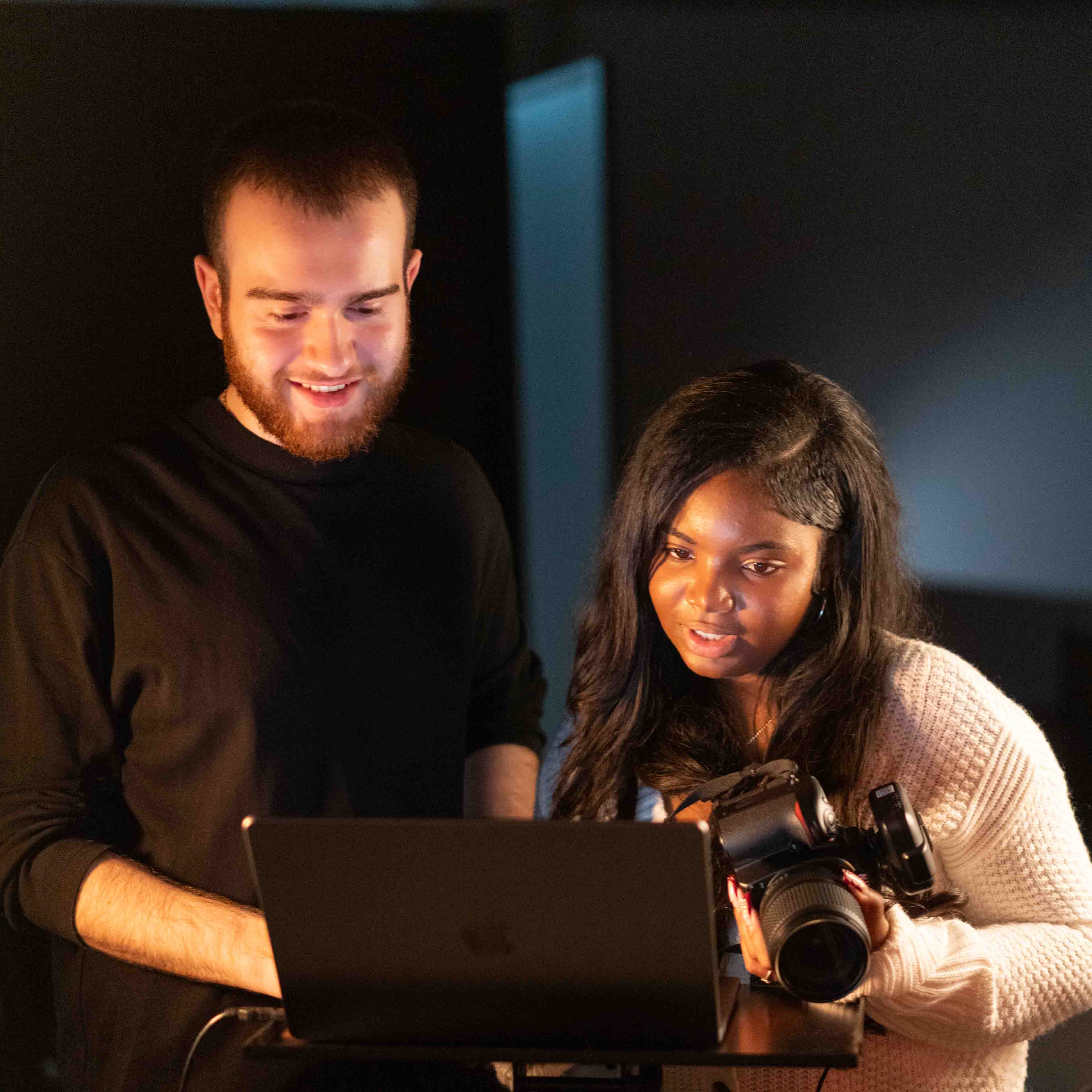 A student holds a camera to take a picture
