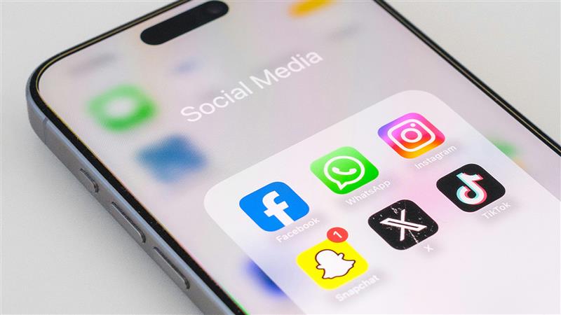 A phone shows a list of social media apps