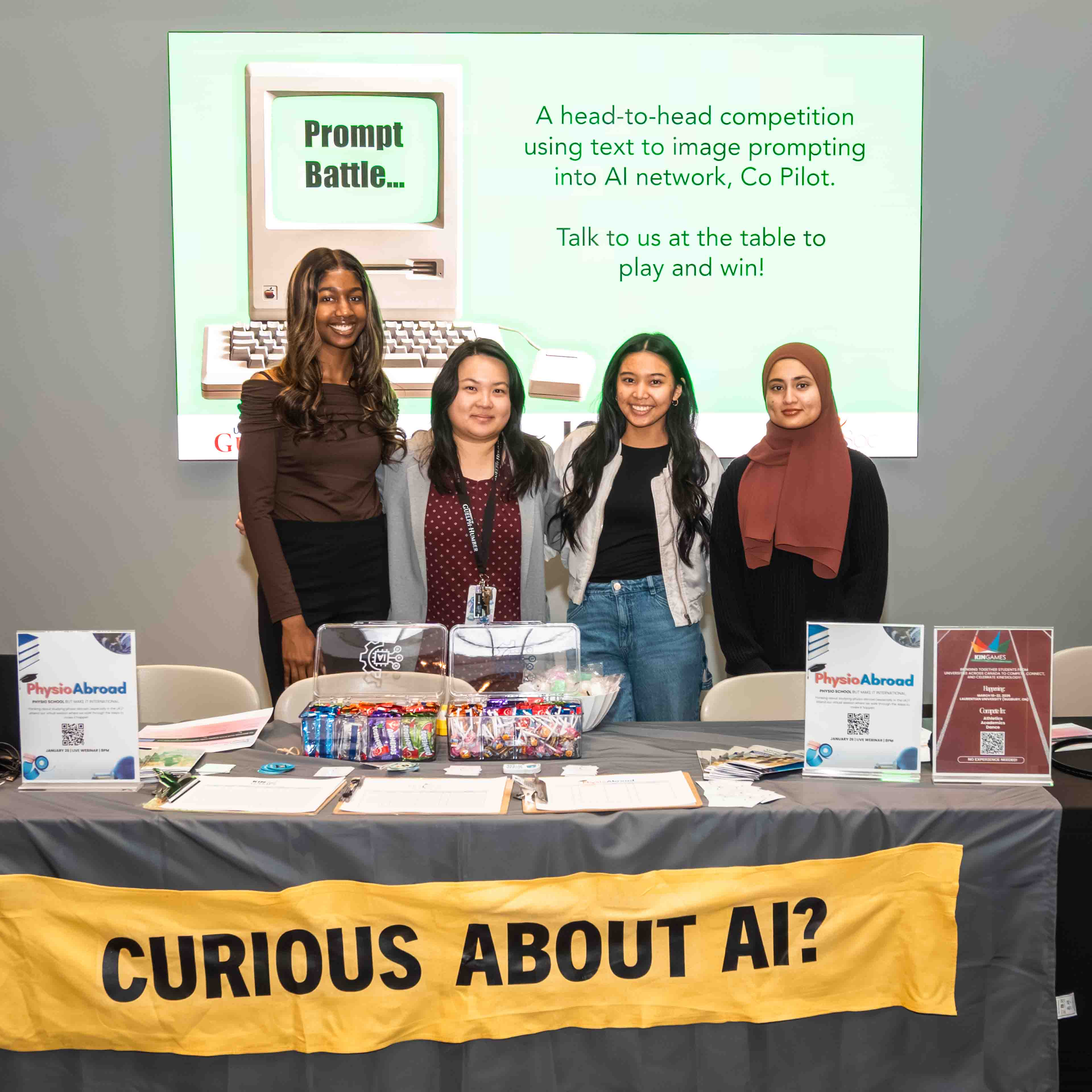 Four students stand at a booth with a banner that says "curious about ai?"