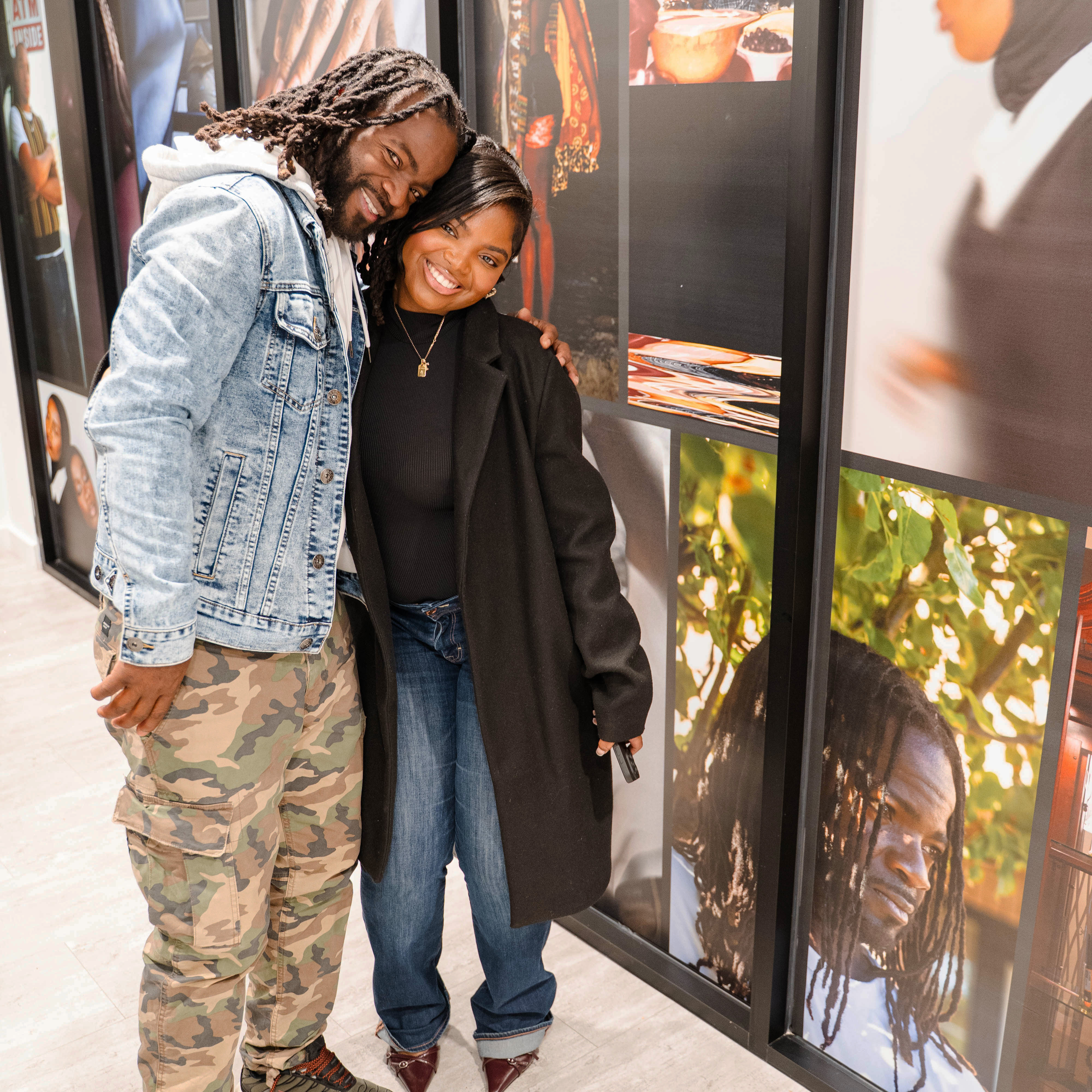 Tamia McPherson stands with her father at the mural