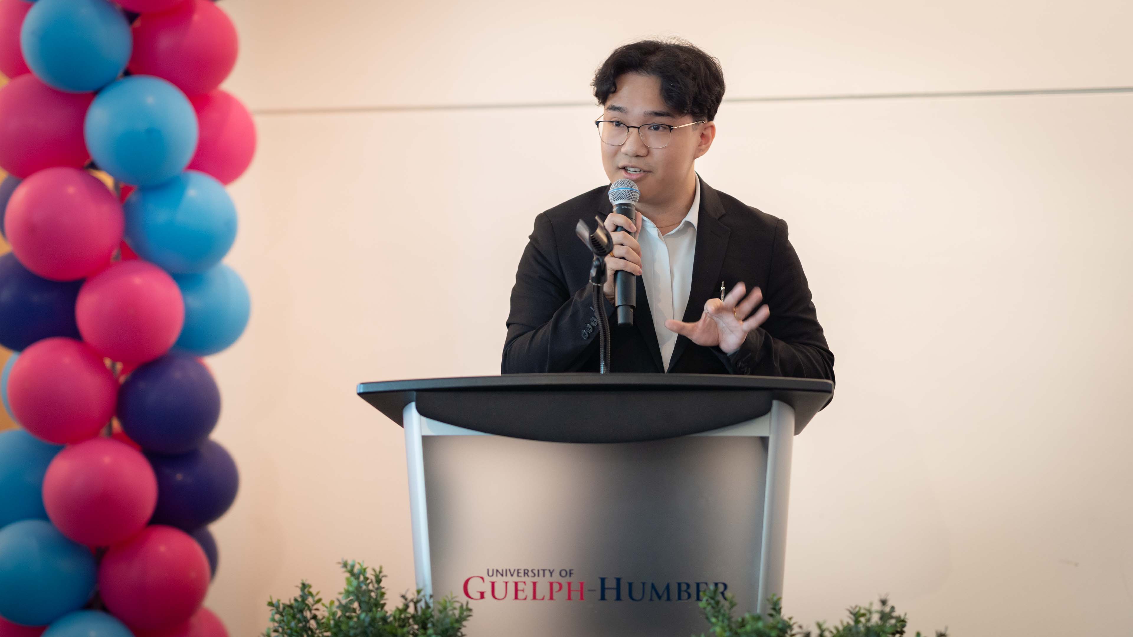 Aaron Dawang gives a speech at a podium