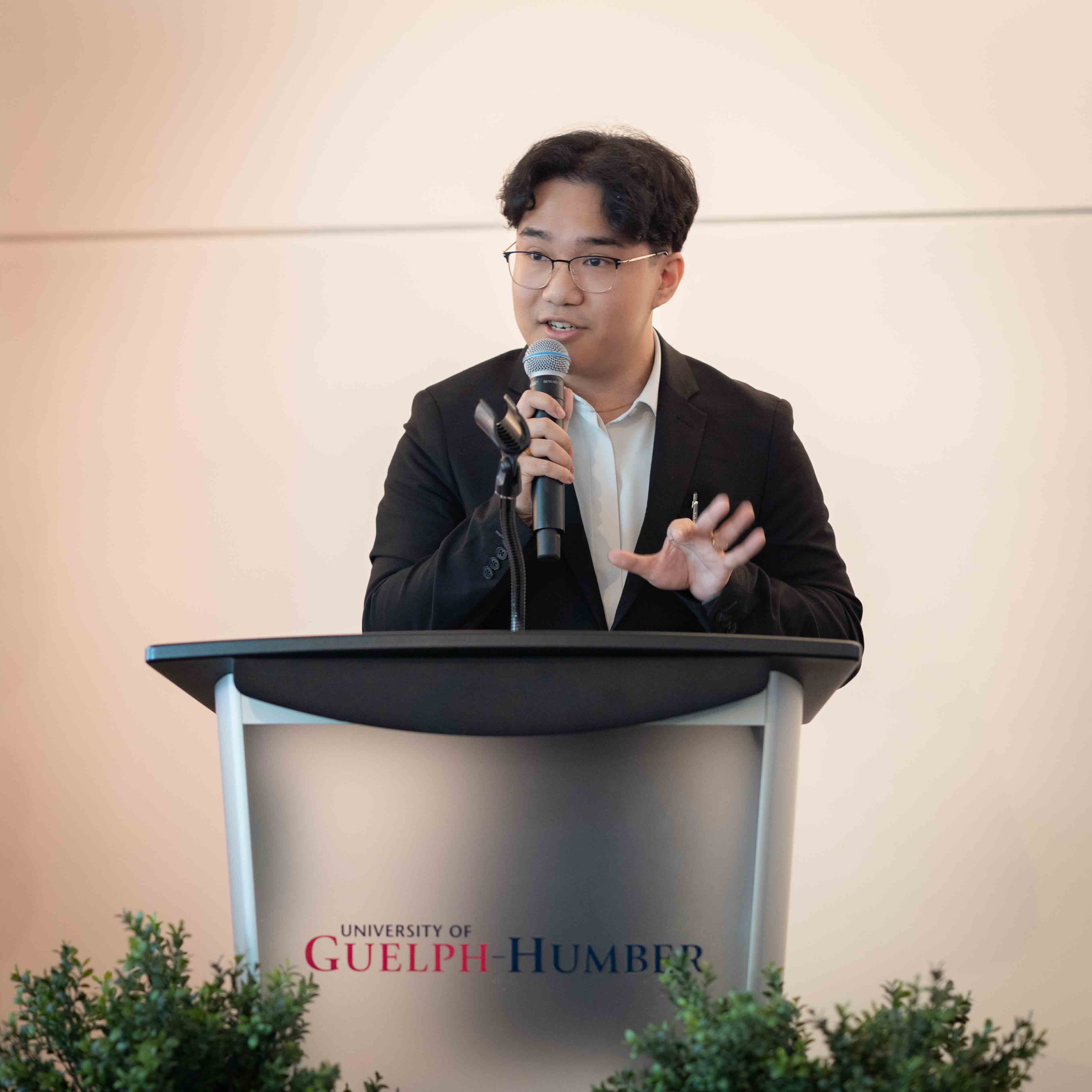 Aaron Dawang gives a speech at a podium