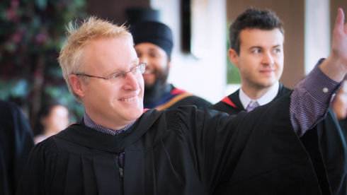 Faculty waving at convocation 2014