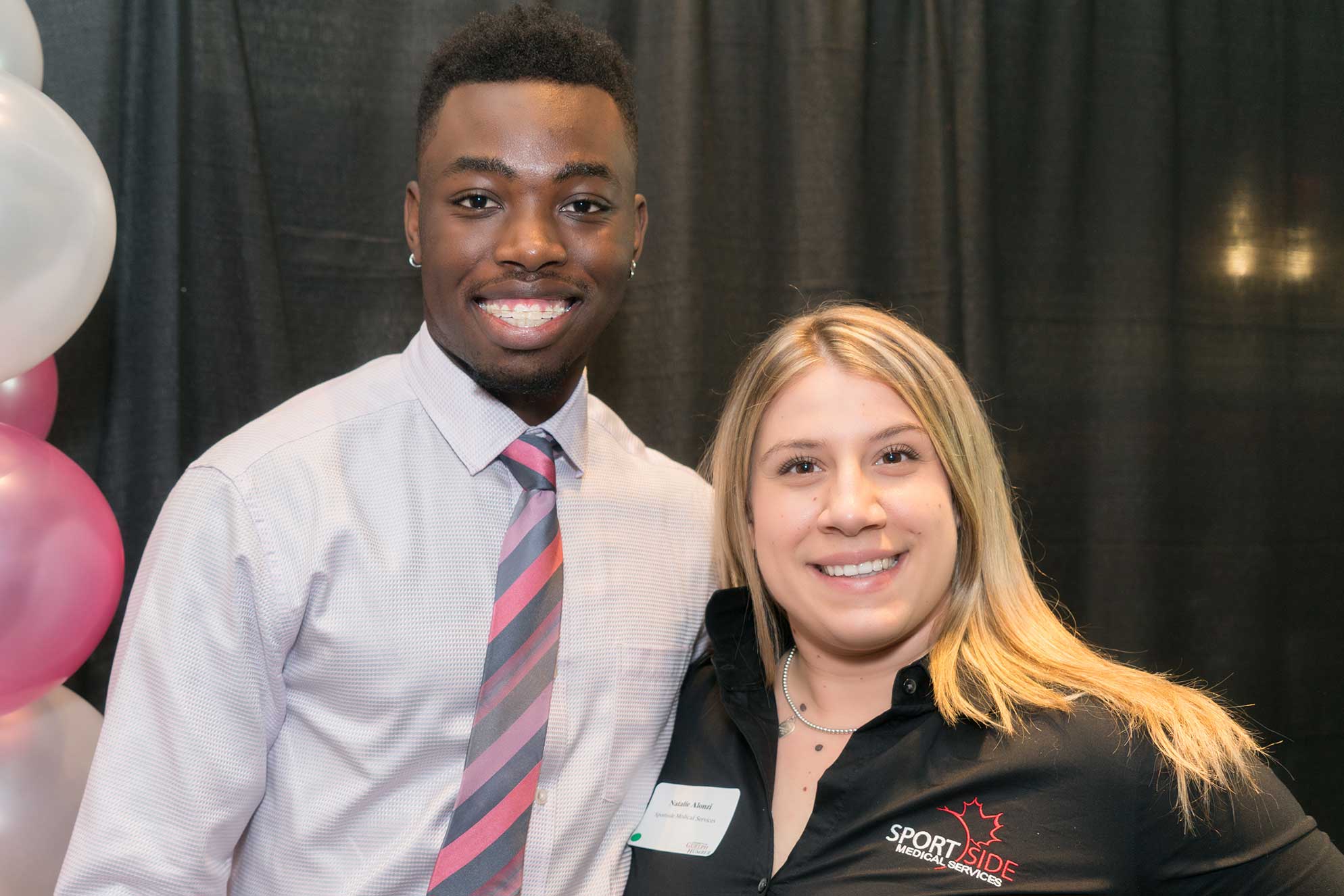 Malik Carby-Corbett smiles with a guest