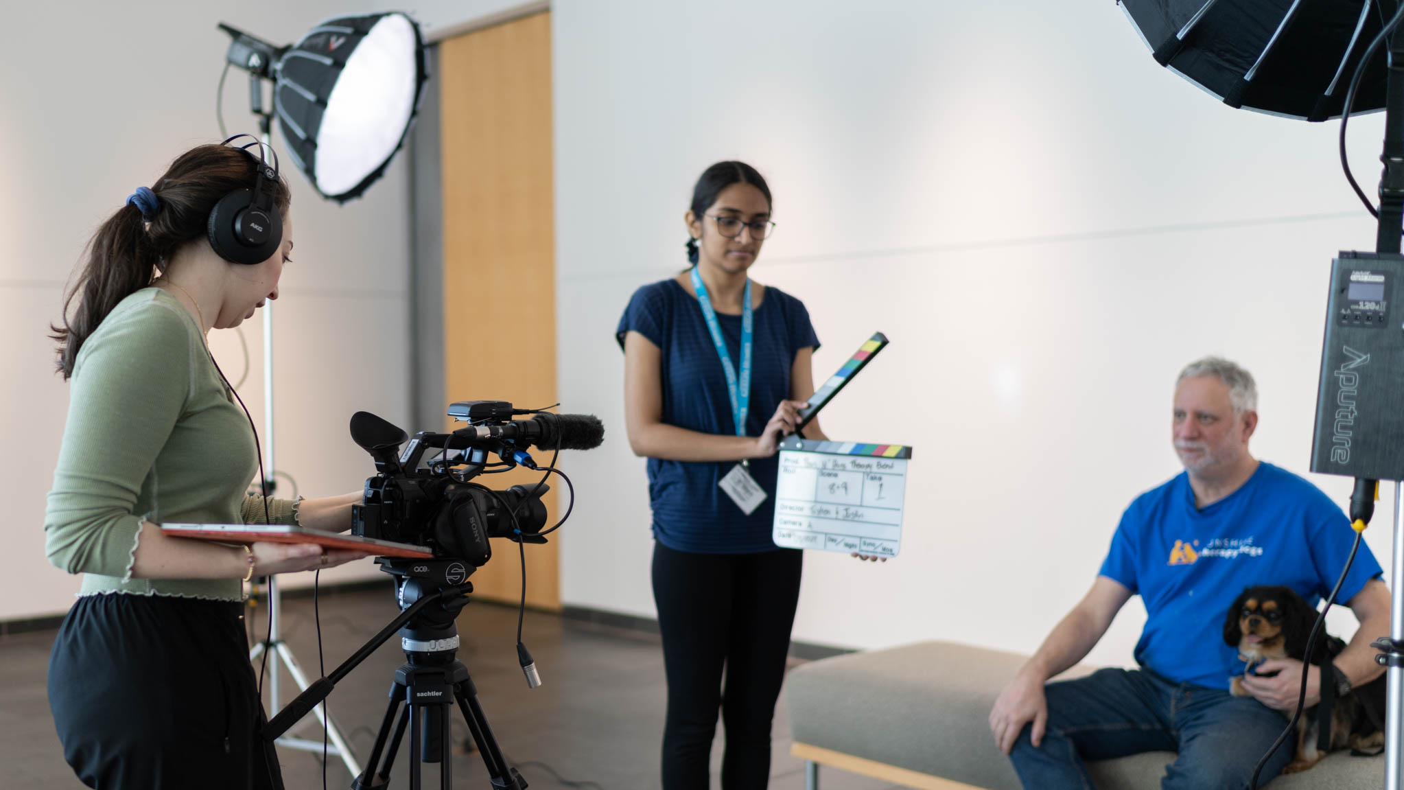 Students filming sunshine therapy dog scene