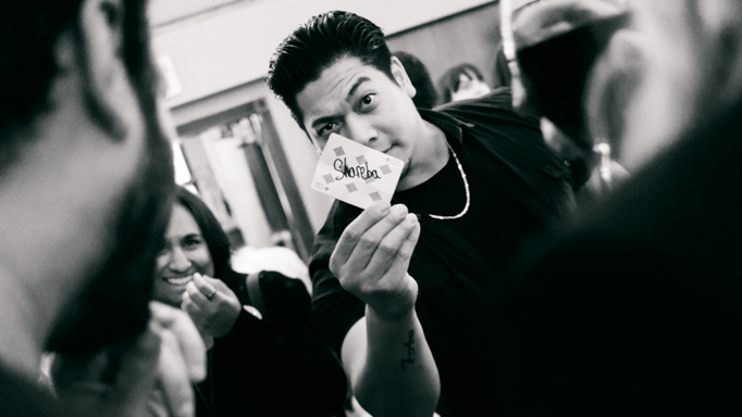 An illusionist performs a card trick